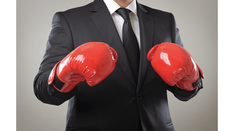 man in suit wearing boxing gloves