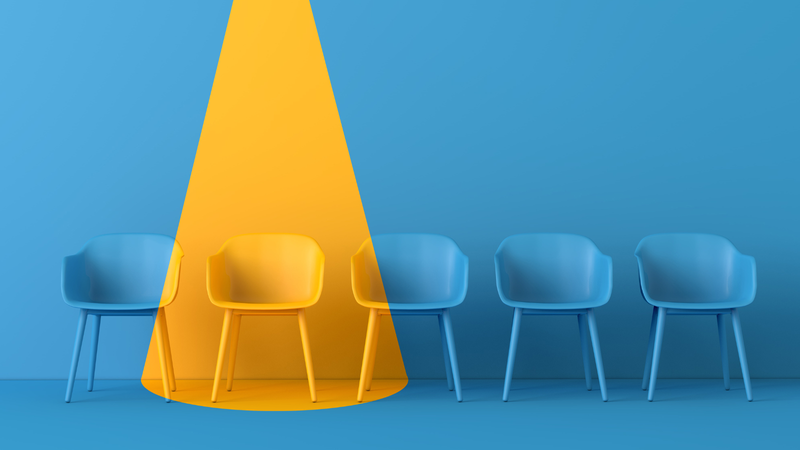 A spotlight on a yellow chair in a row of blue chairs