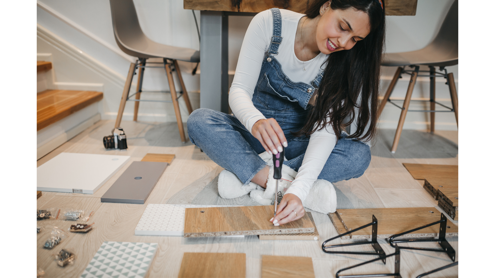 A woman putting together furniture