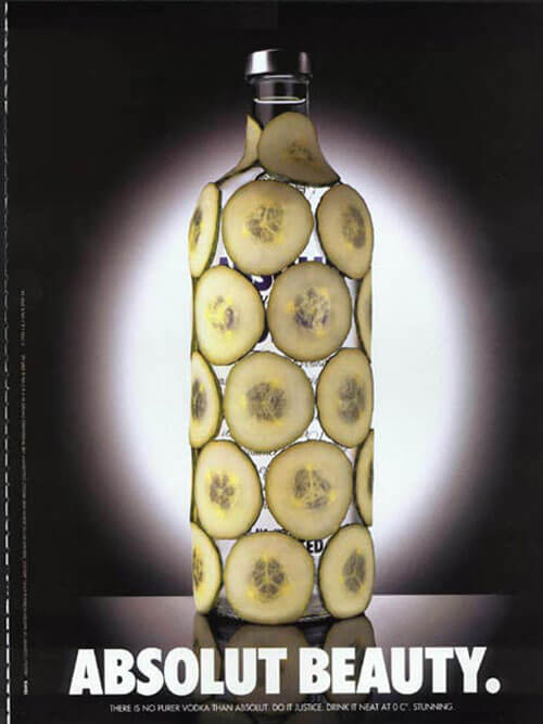 An Absolut Vodka bottle covered in cucumber slices. The headline is Absolut Beauty