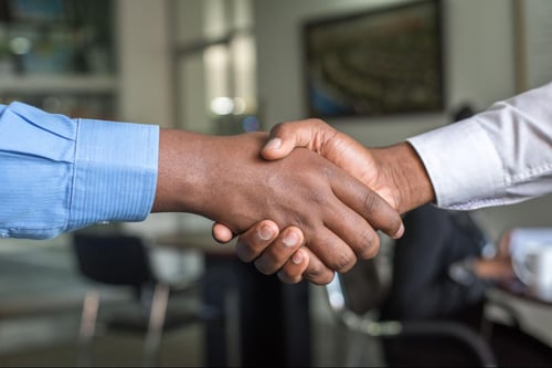 A closeup of two people shaking hands