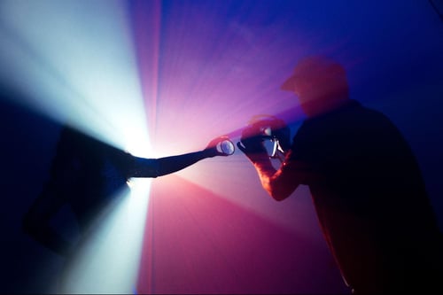 Man taking a photo through a prism