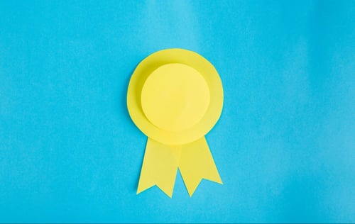 Yellow award ribbon on light blue background