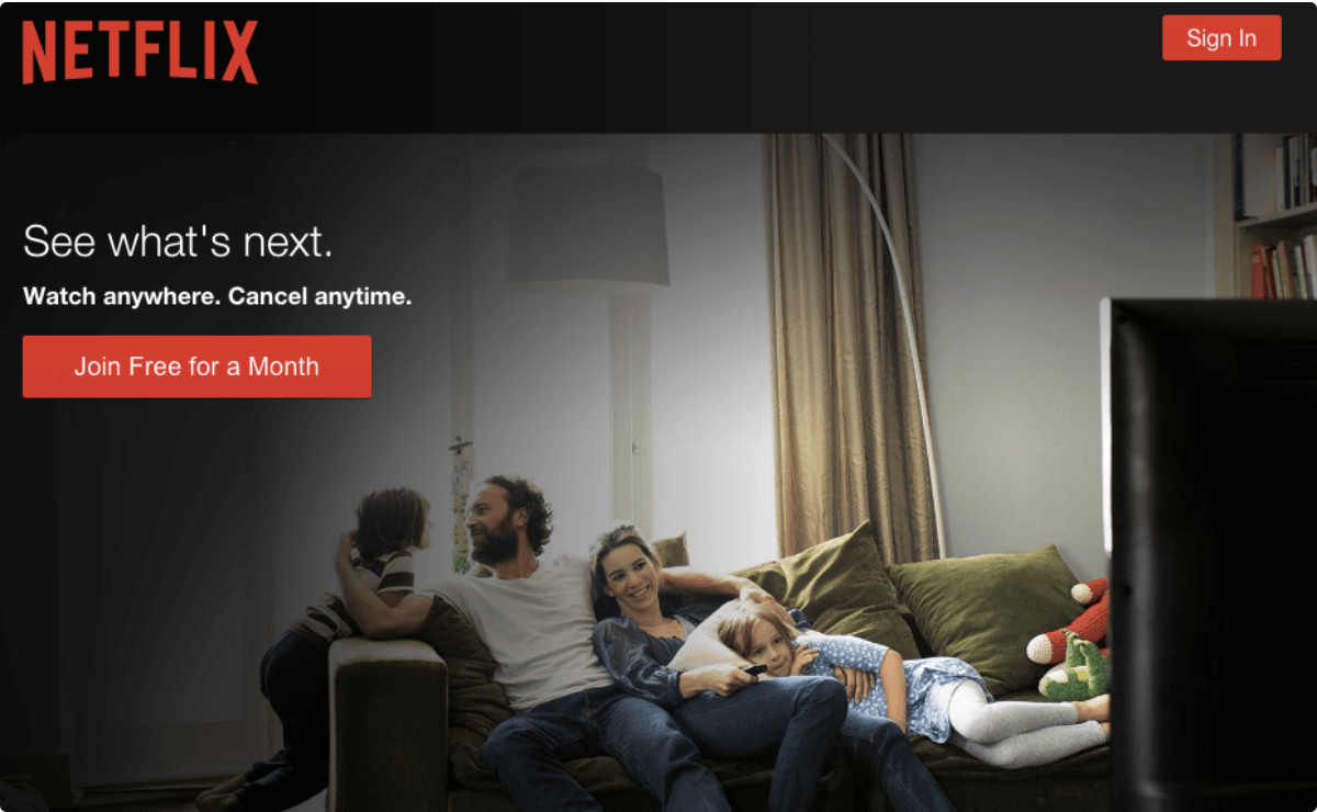 Netflix's homepage, featuring an image of a family watching TV together. 