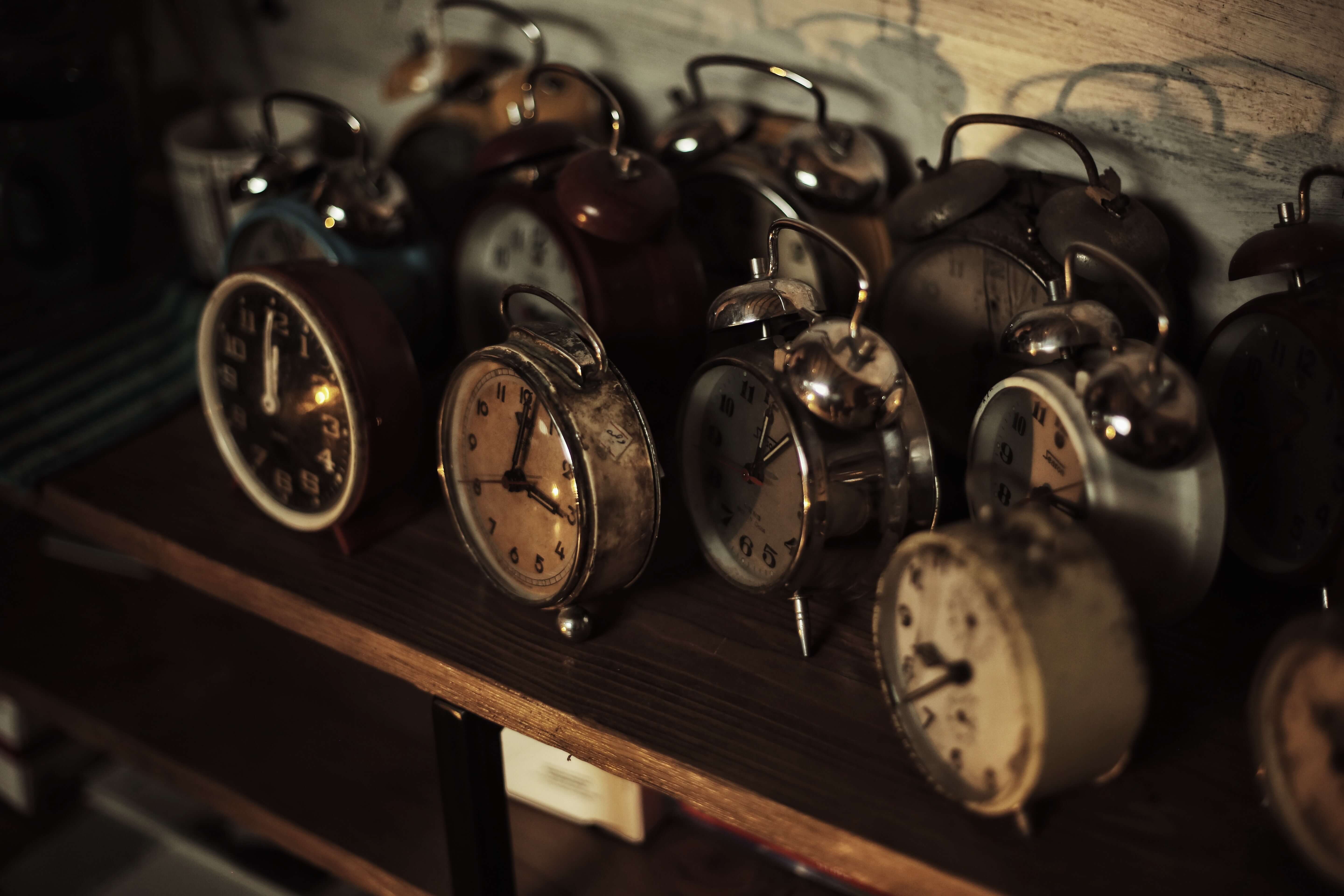 A collection of vintage clocks on a shelf