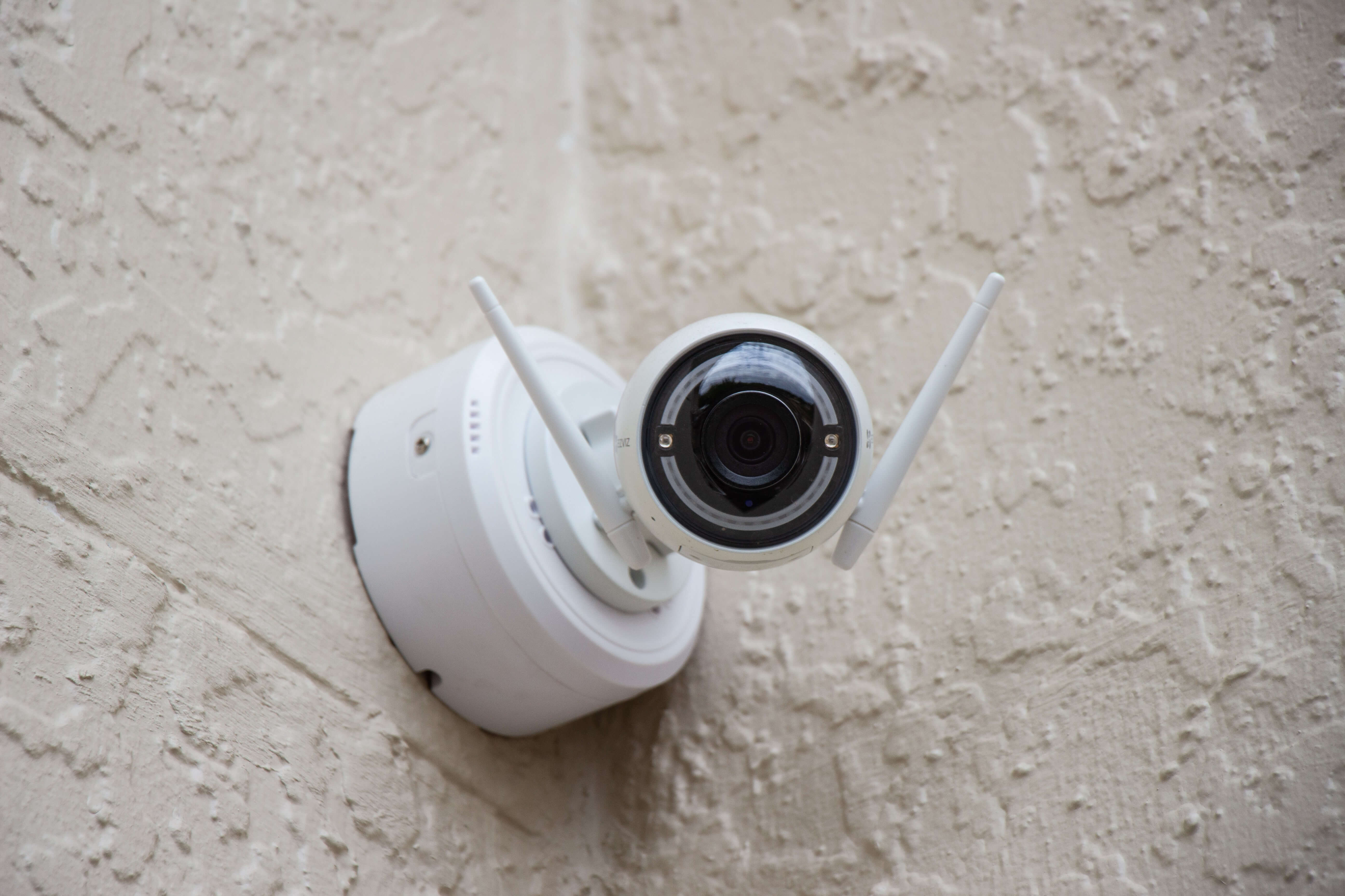 A security camera mounted on an exterior wall