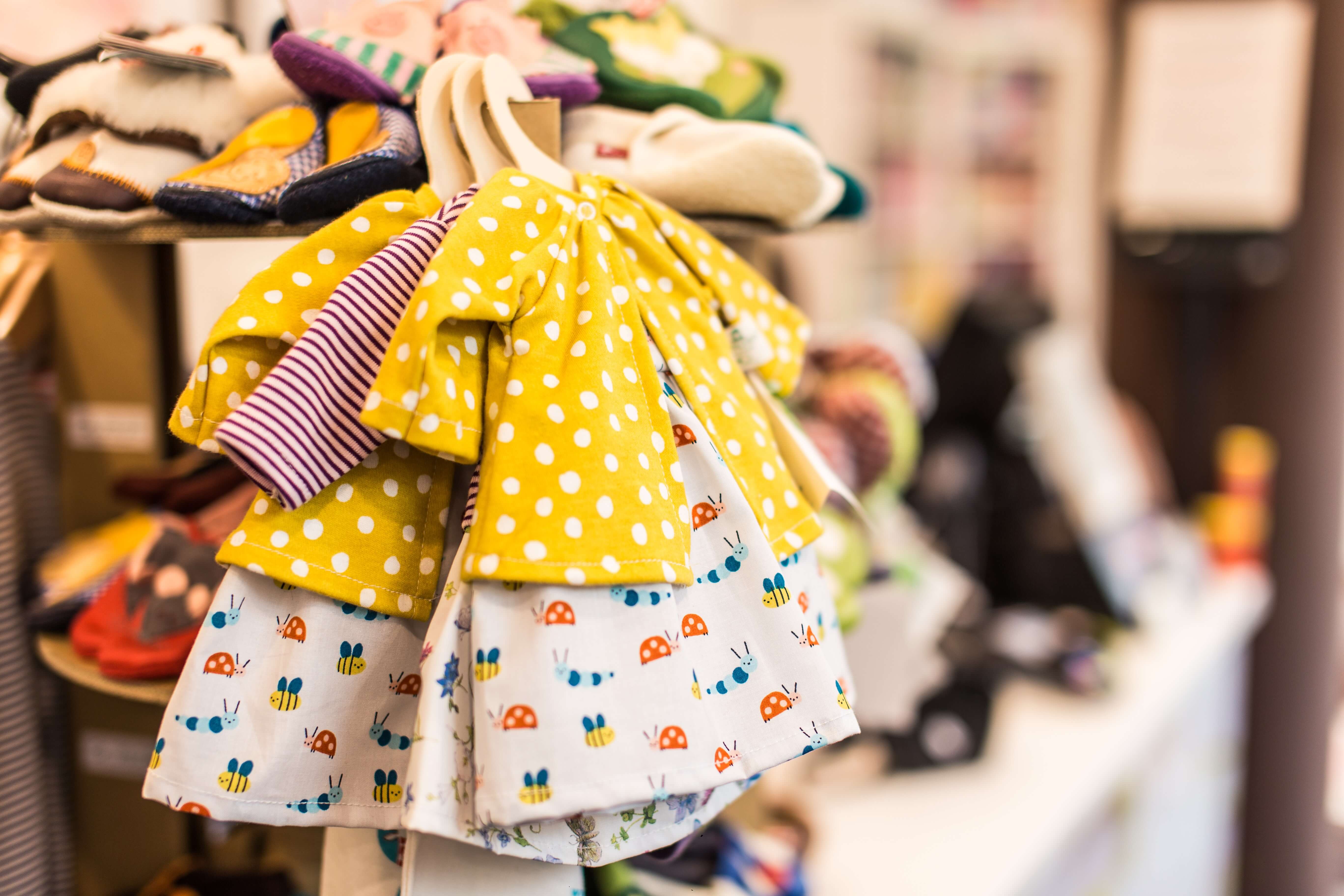 Three baby outfits on little hangers