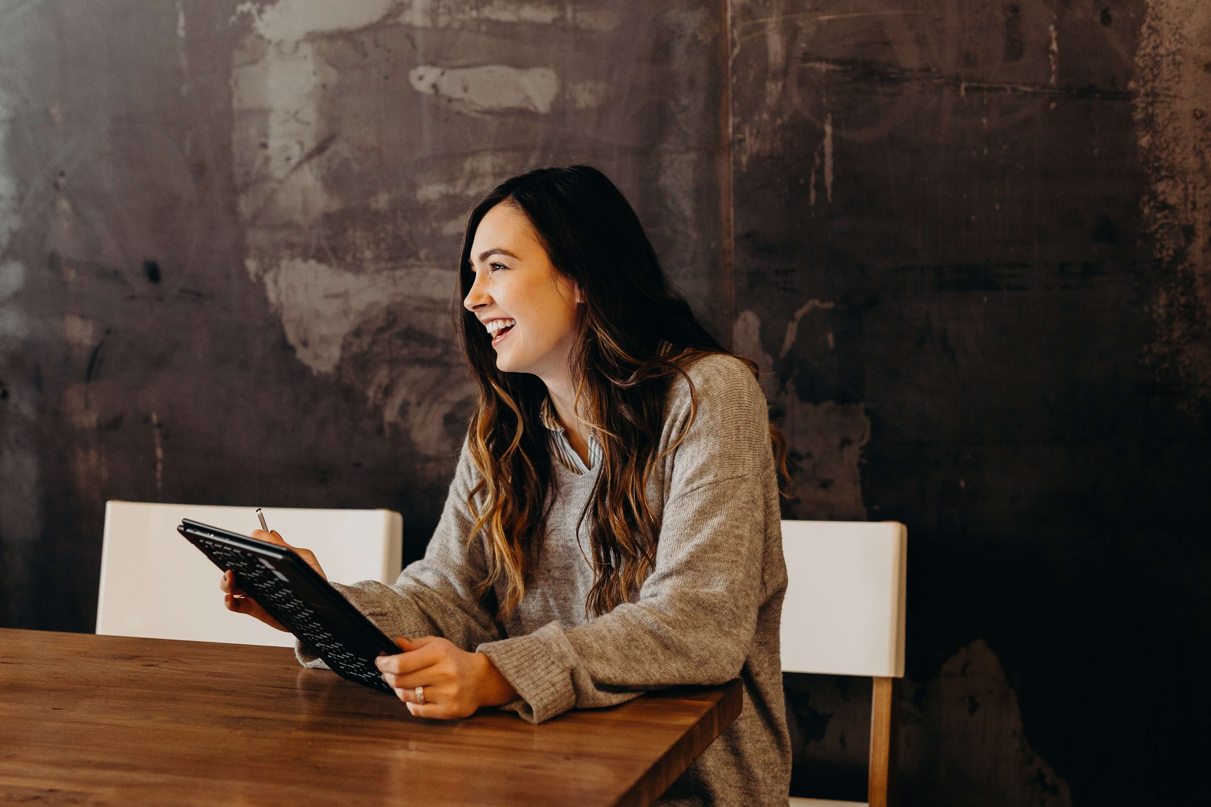 A young white woman using a tablet