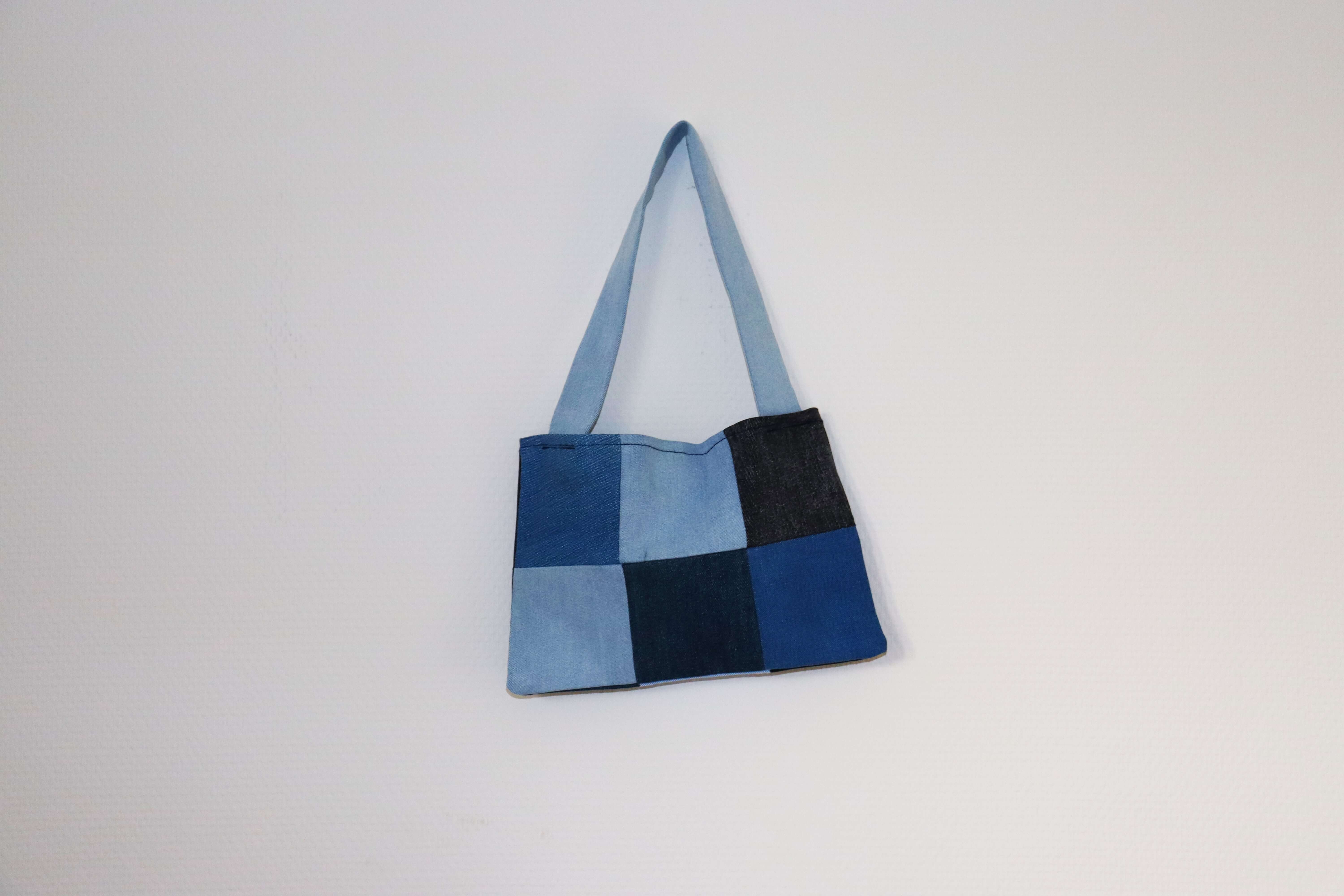 A tote bag made of fabric squares in different shades of blue