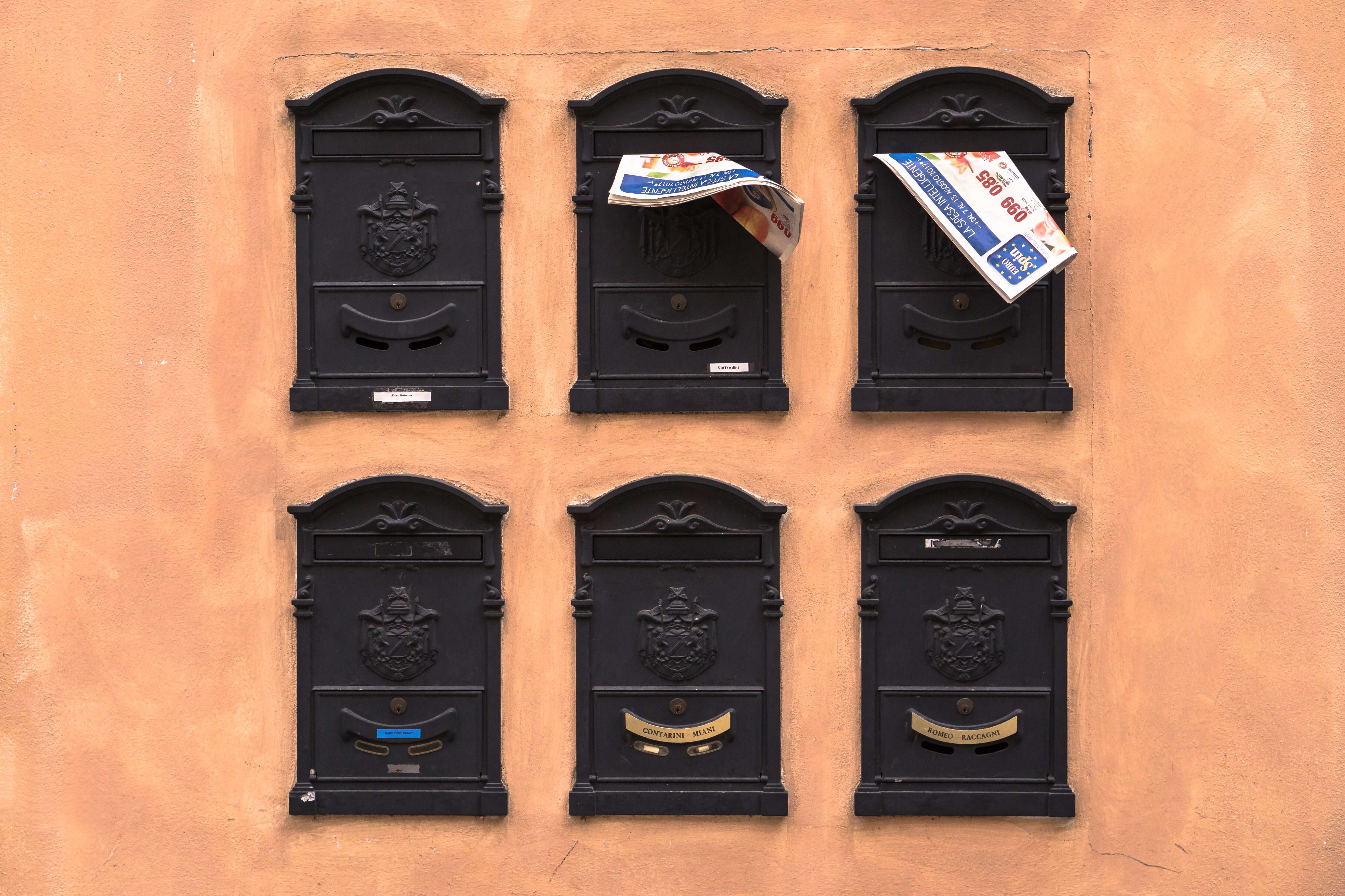 Six old-timey black mailboxes in two rows of three