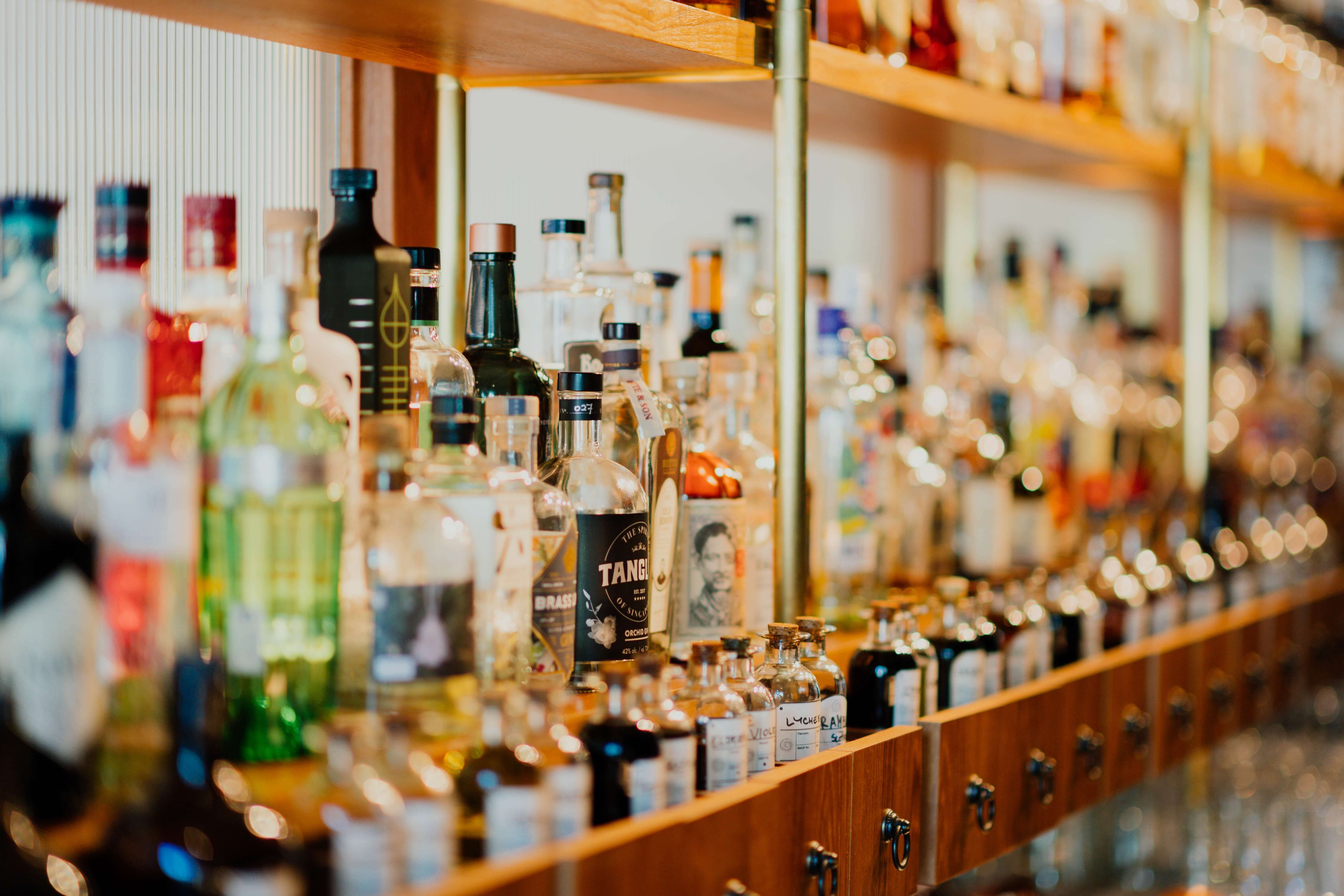 A shelf of alcohol at a bar