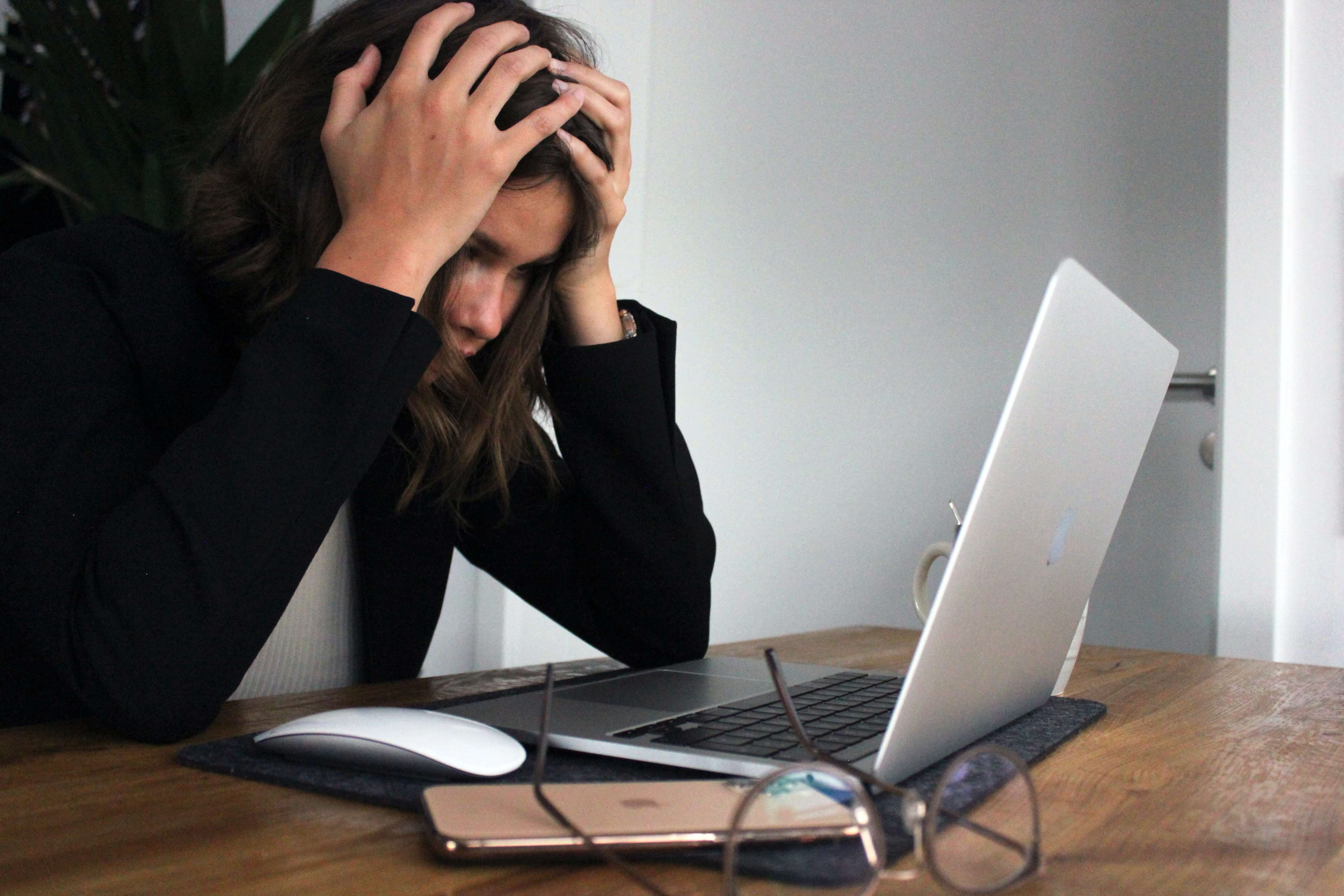 A woman using a computer with an exasperated expression