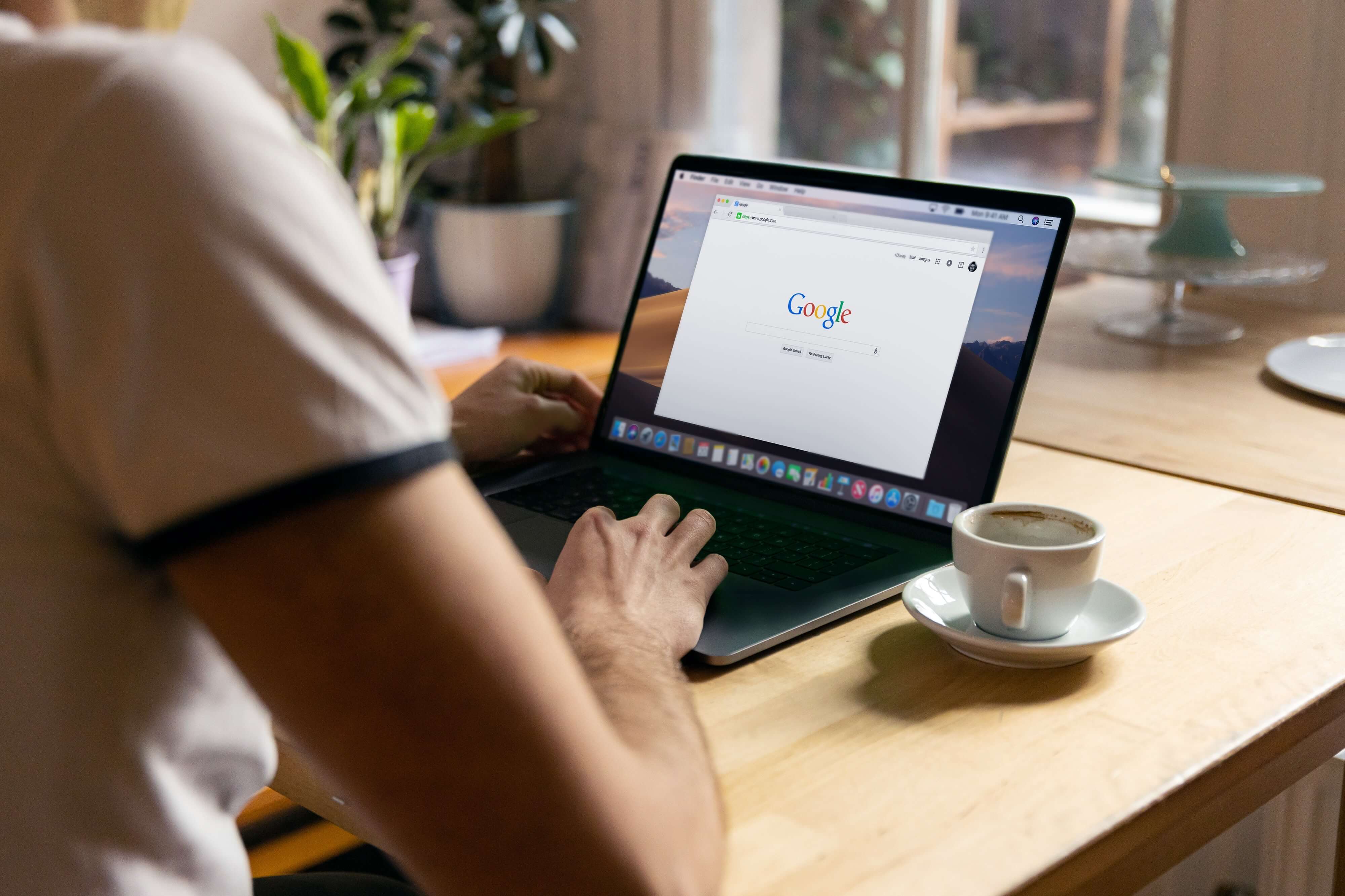 A person doing a Google search on a laptop