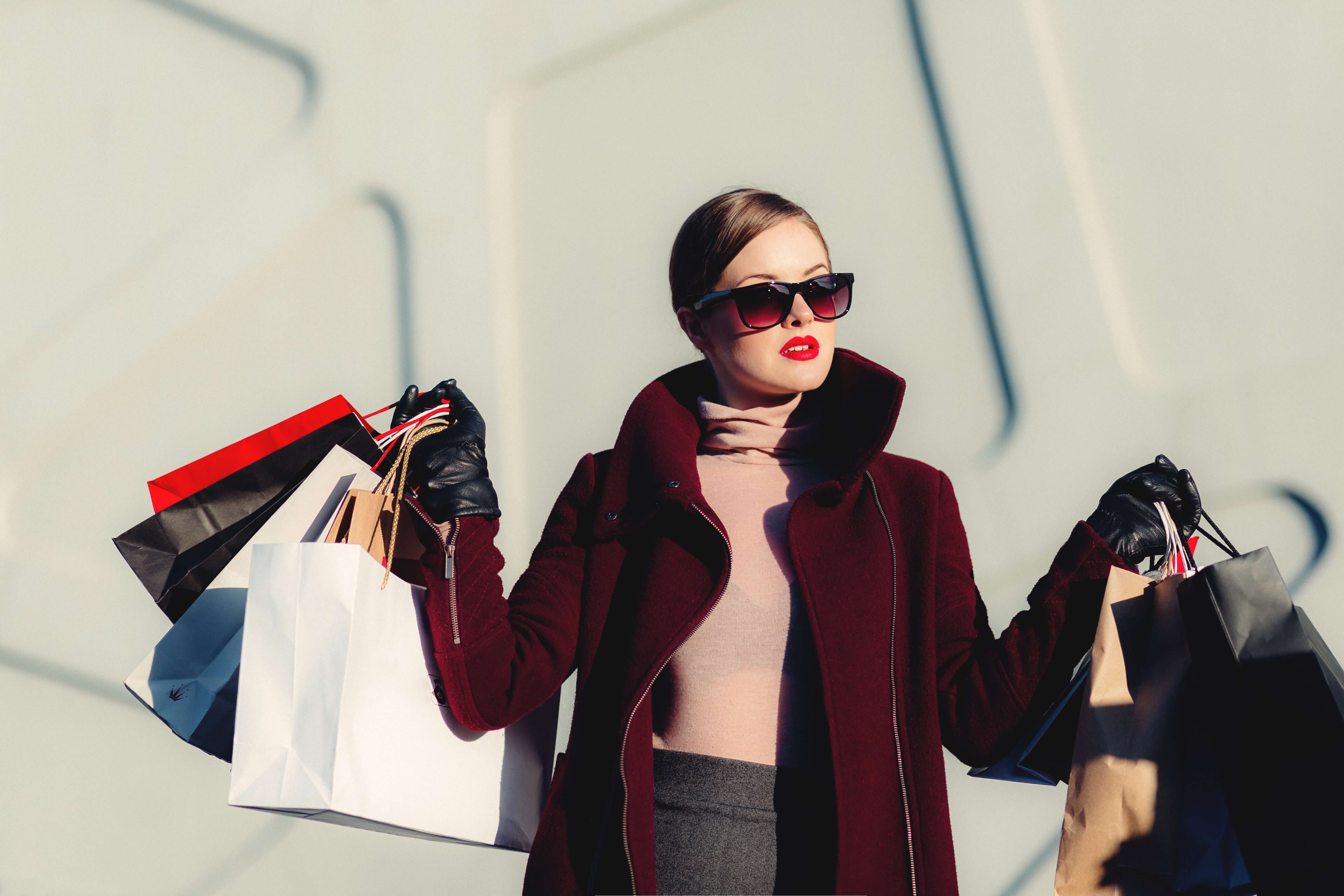 A stylish woman holding shopping bags