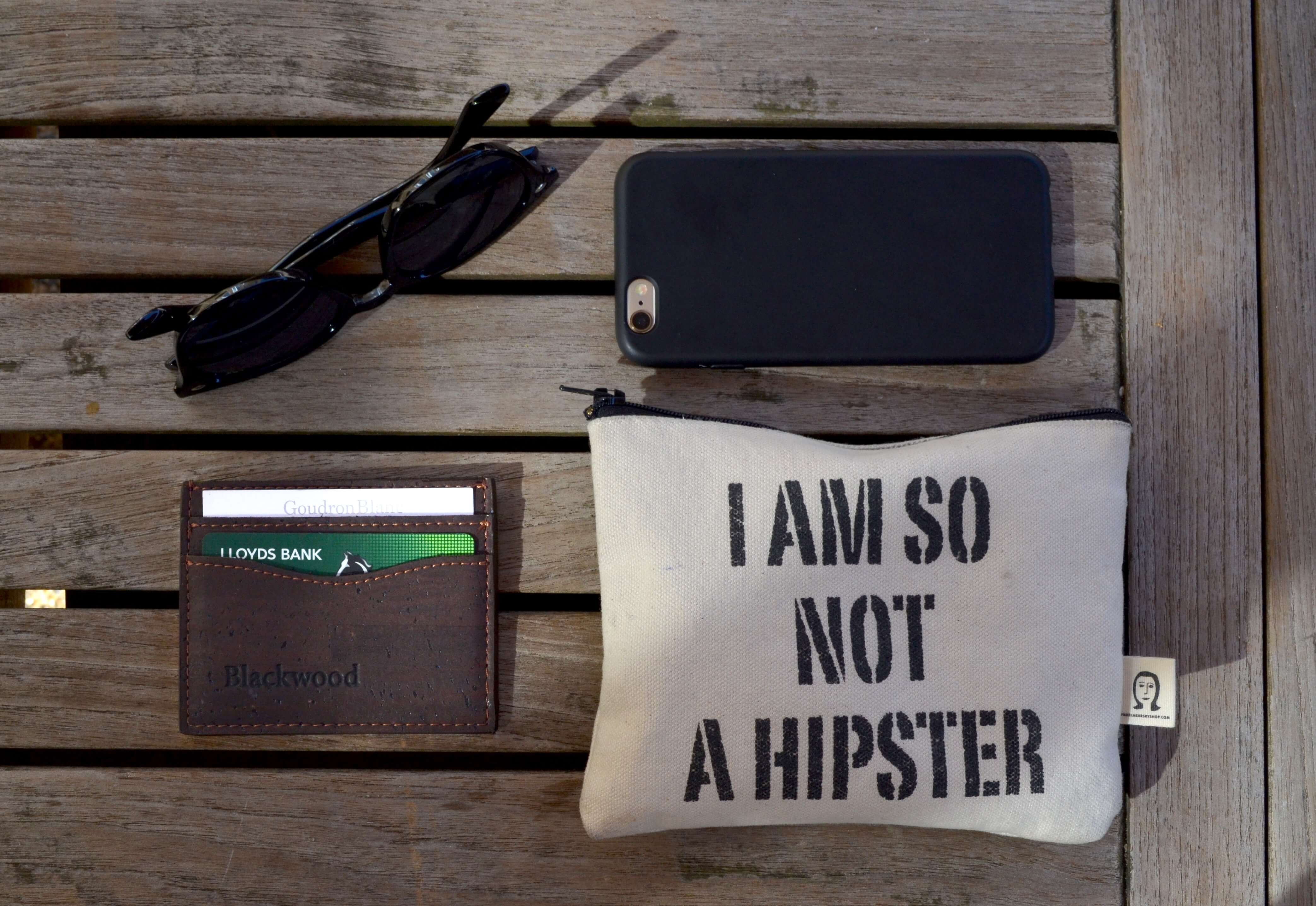 A sunglasses bag with "I AM SO NOT A HIPSTER" printed on it