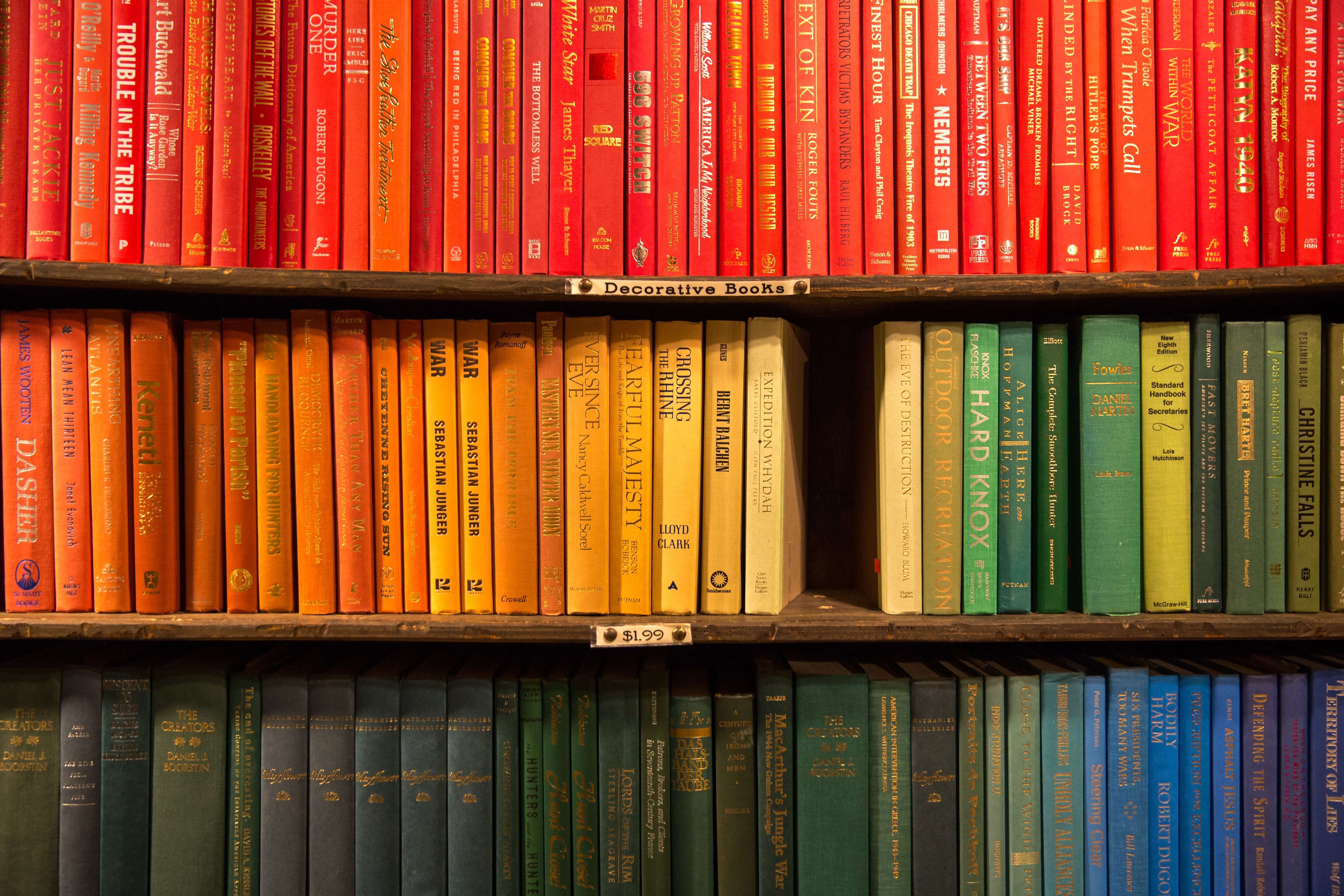 A bookshelf arranged by color