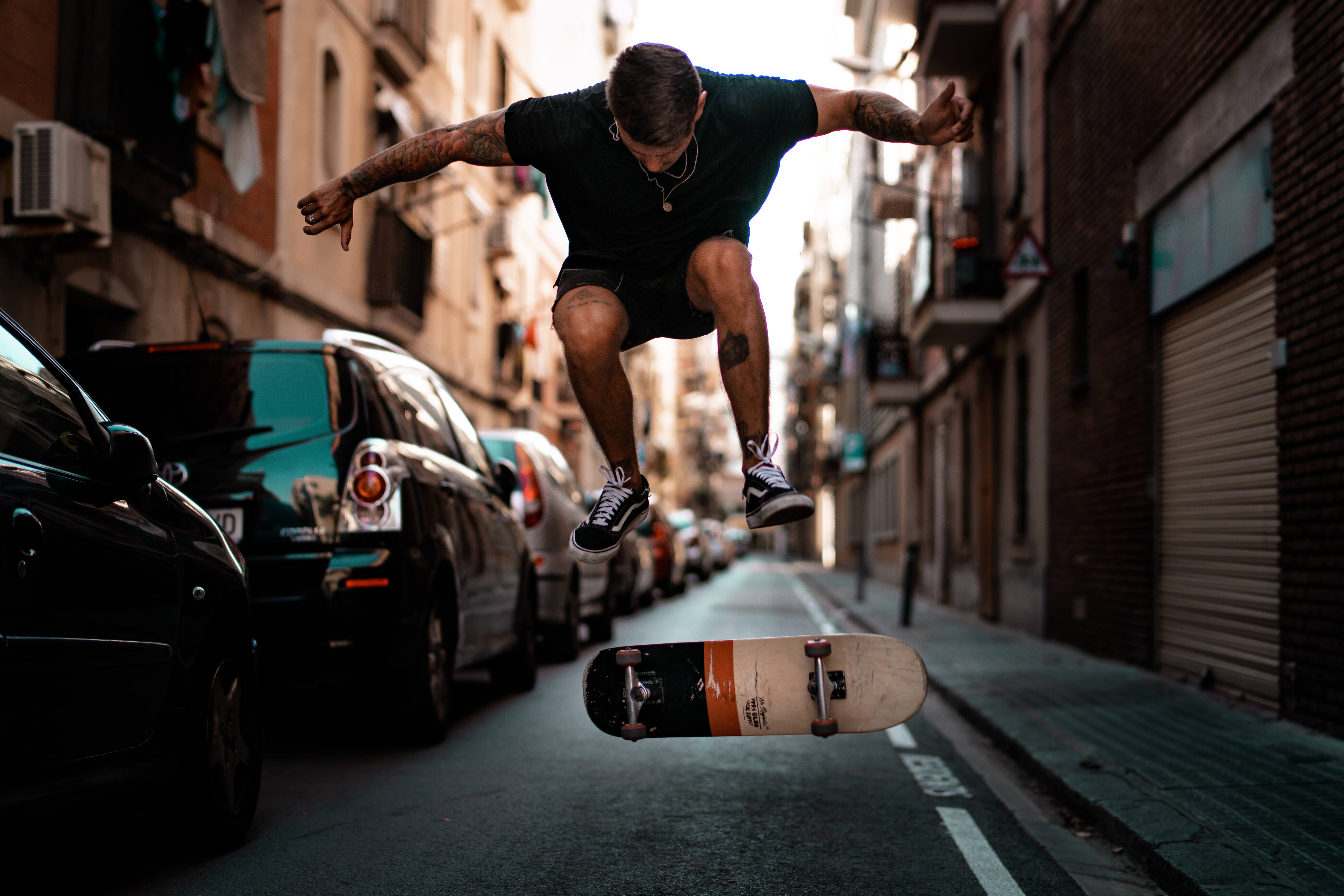 A young man doing a kick flip on a skateboard