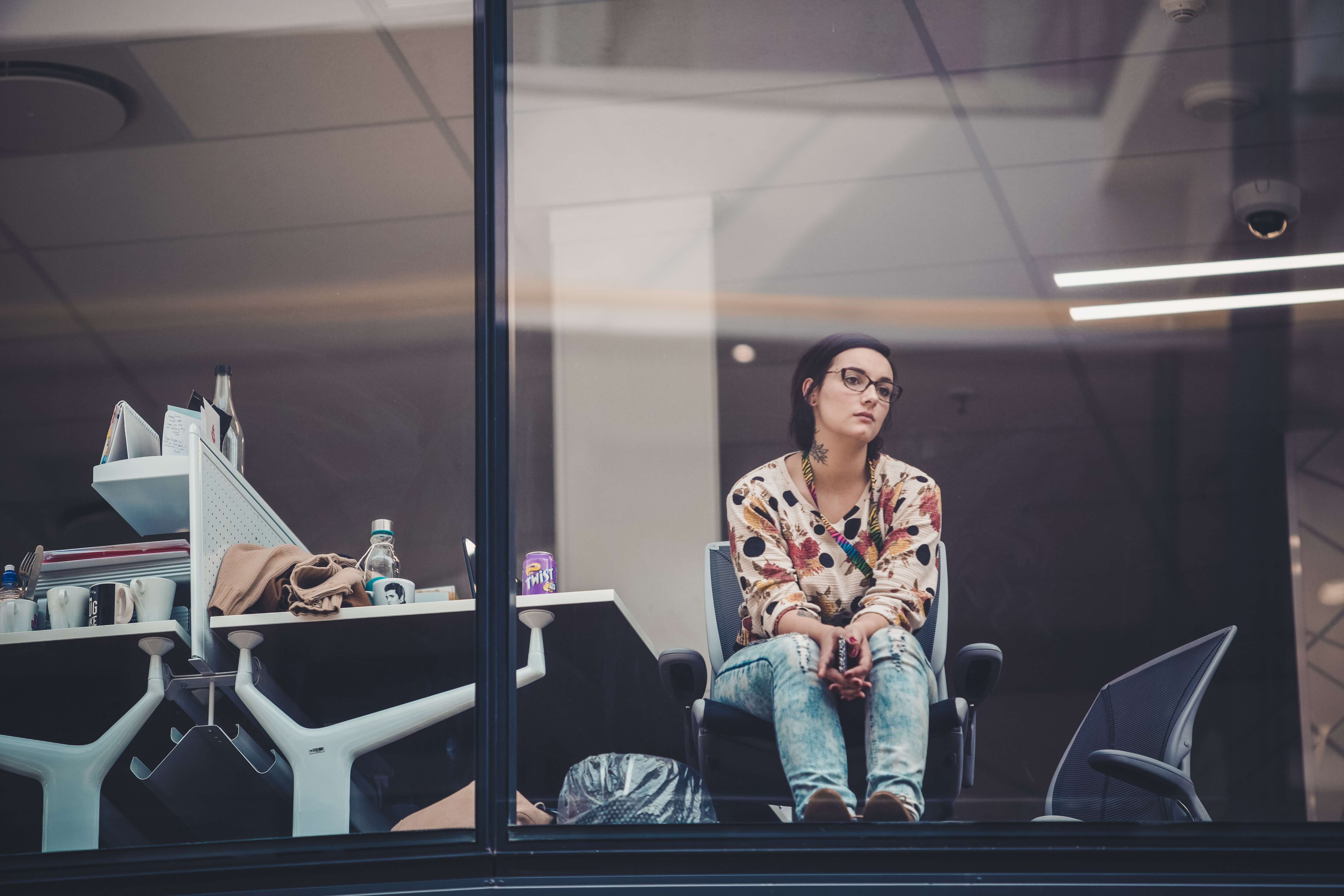 A woman in an office staring out the window