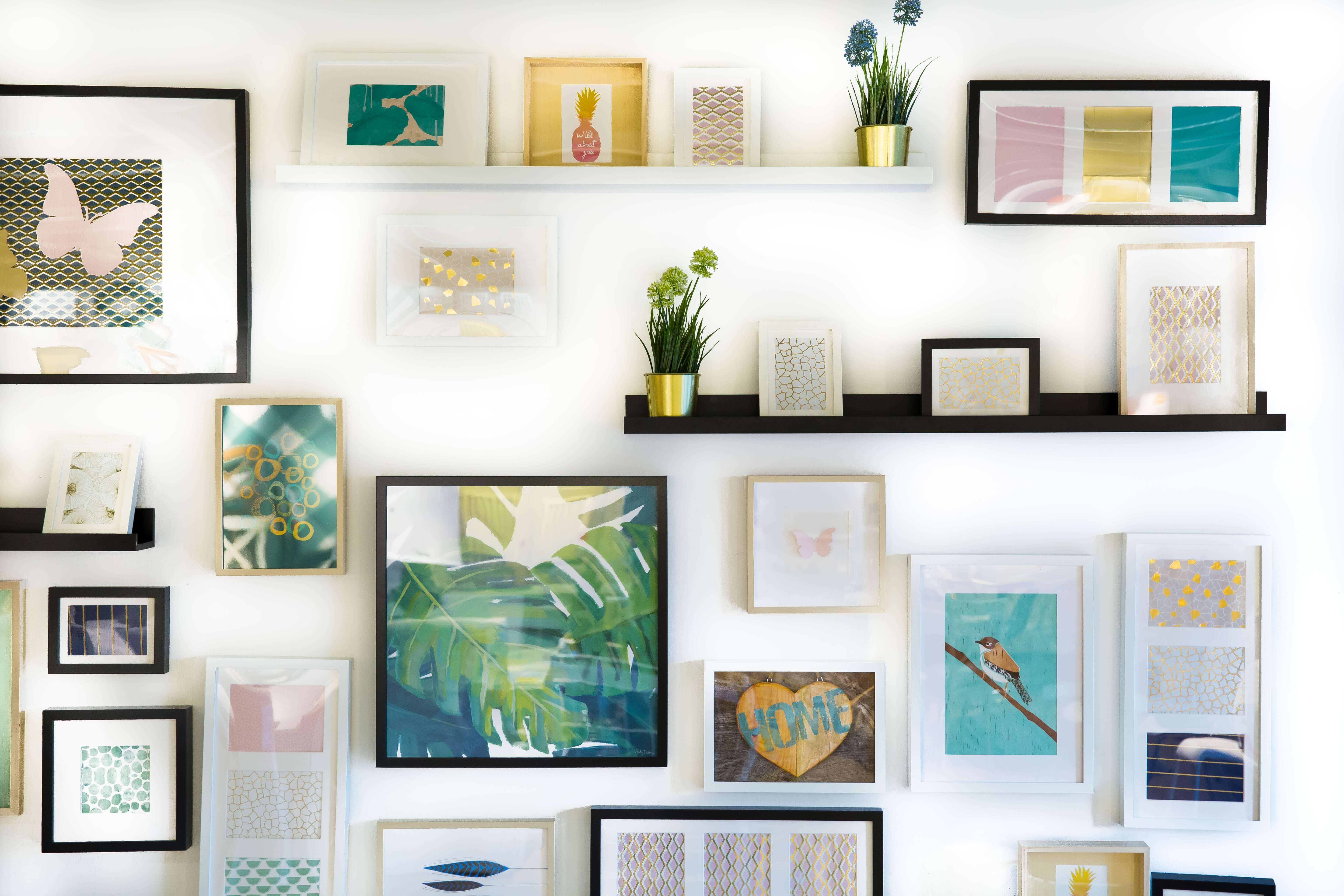 A wall covered in framed art prints