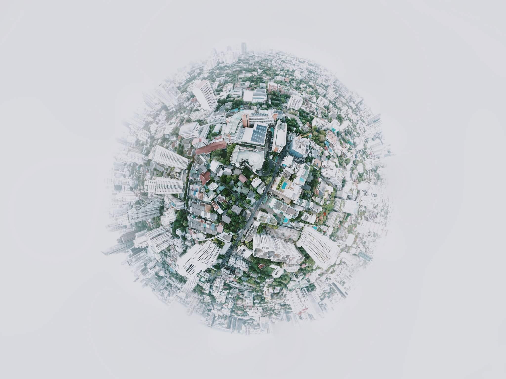 An aerial view of a city distorted to look like a sphere