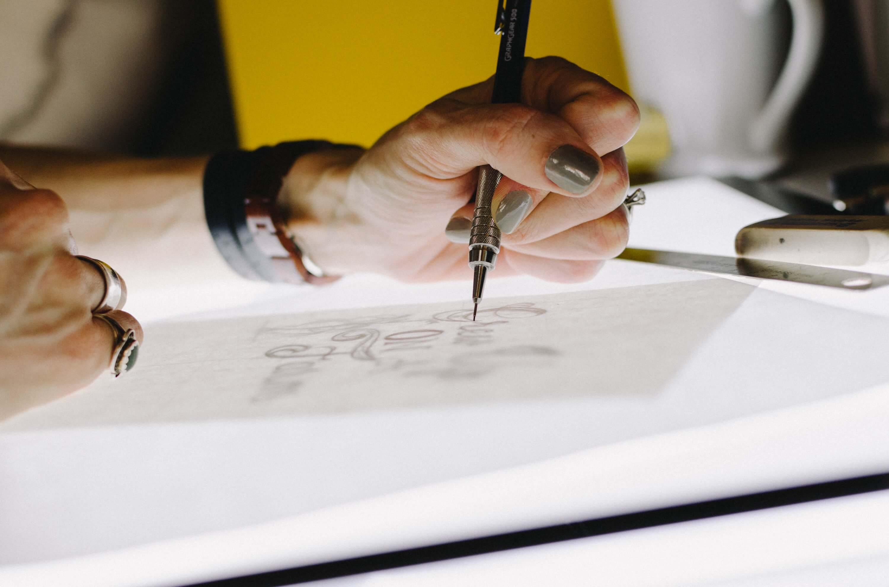 A closeup of a person's hands drawing