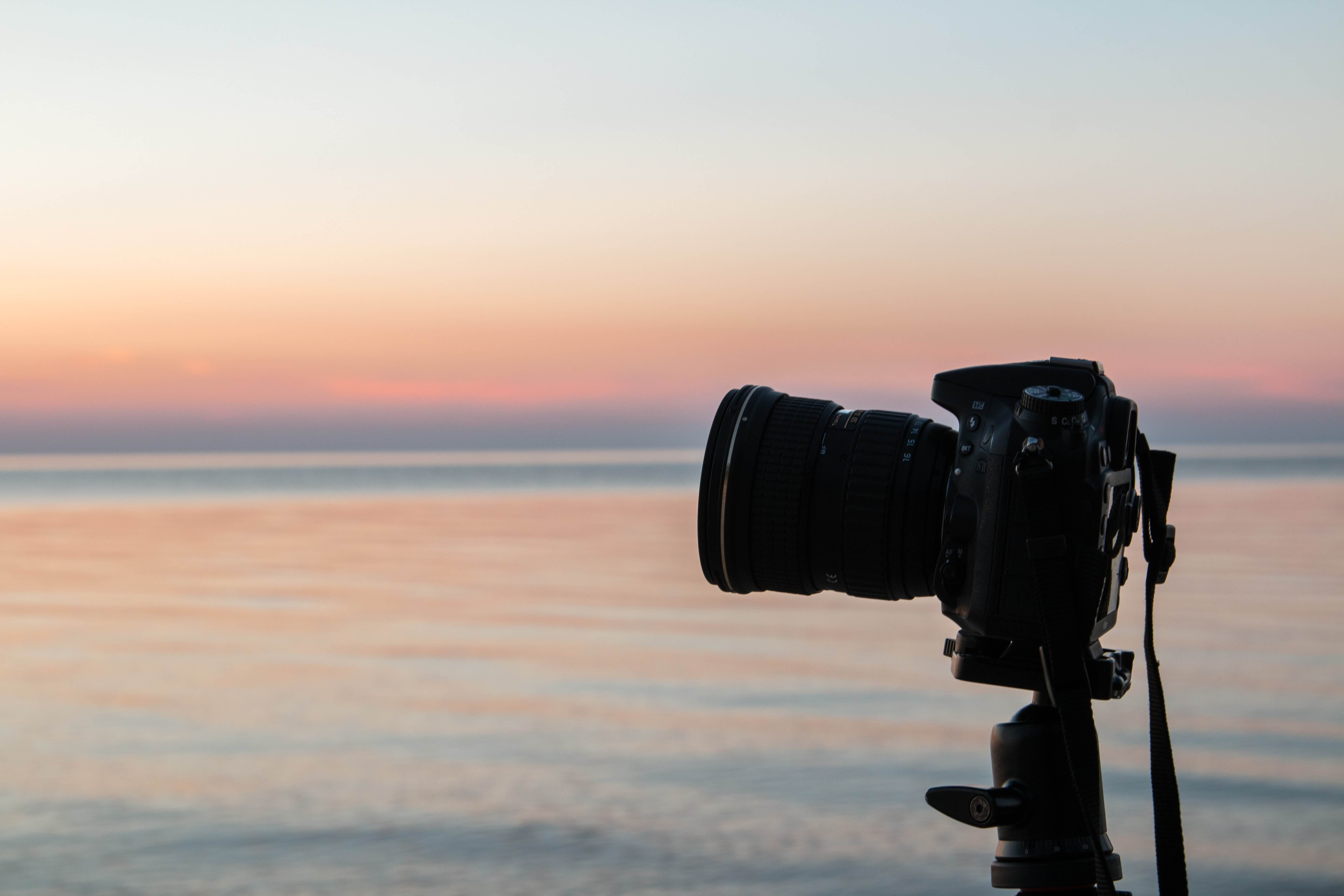 A camera in front of a sunset