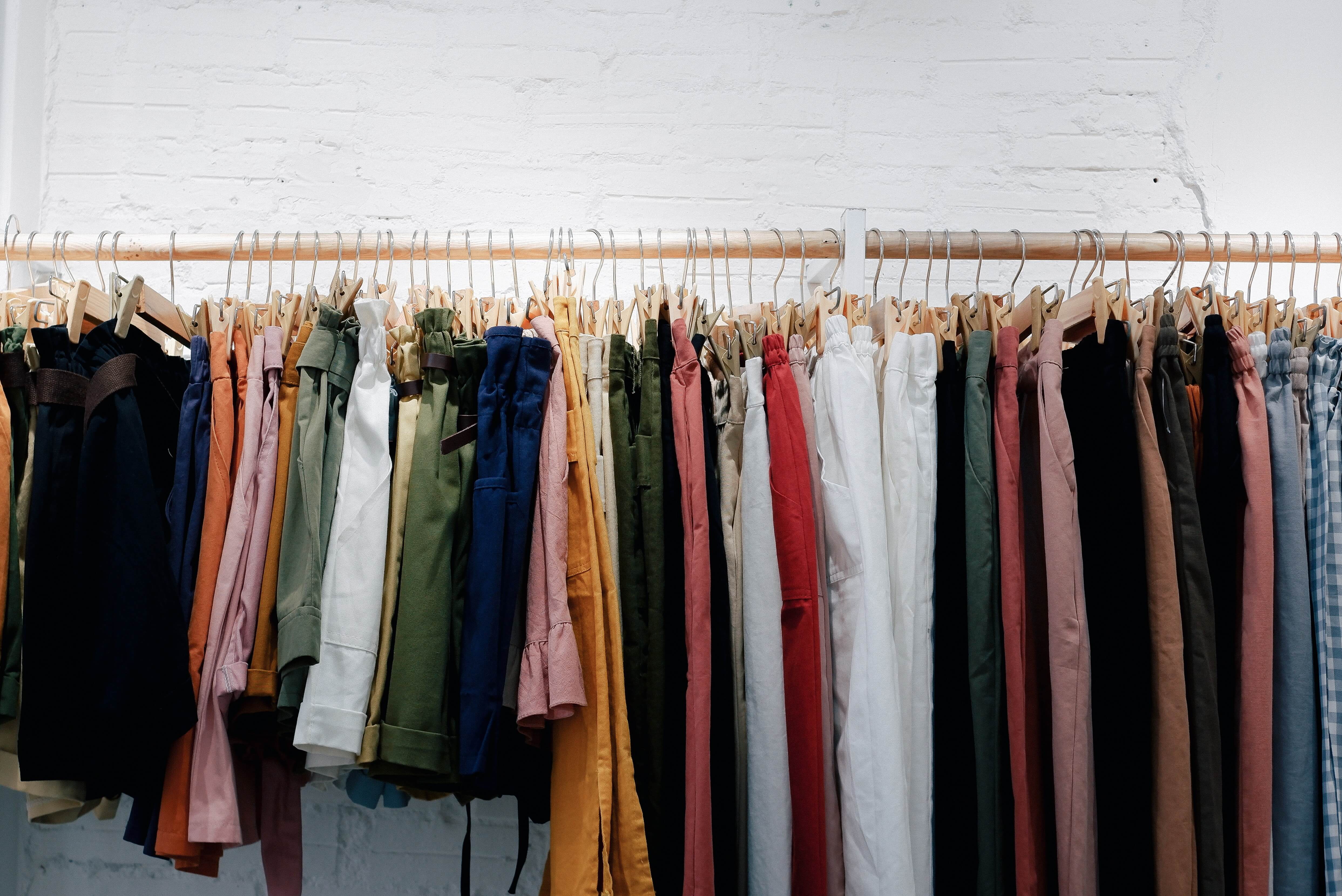 A rack of various colored pants