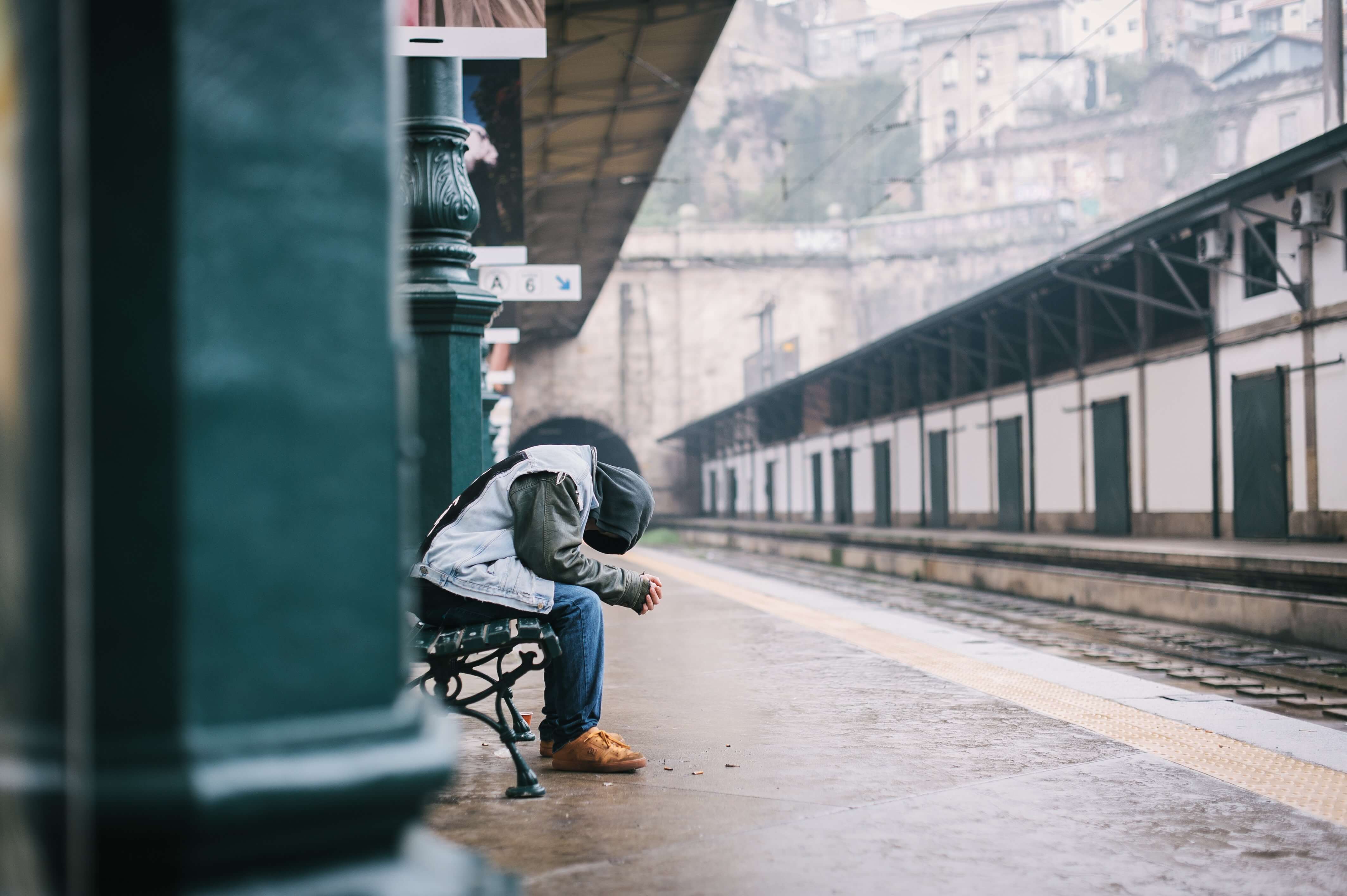 A disappointed man sitting on a bench