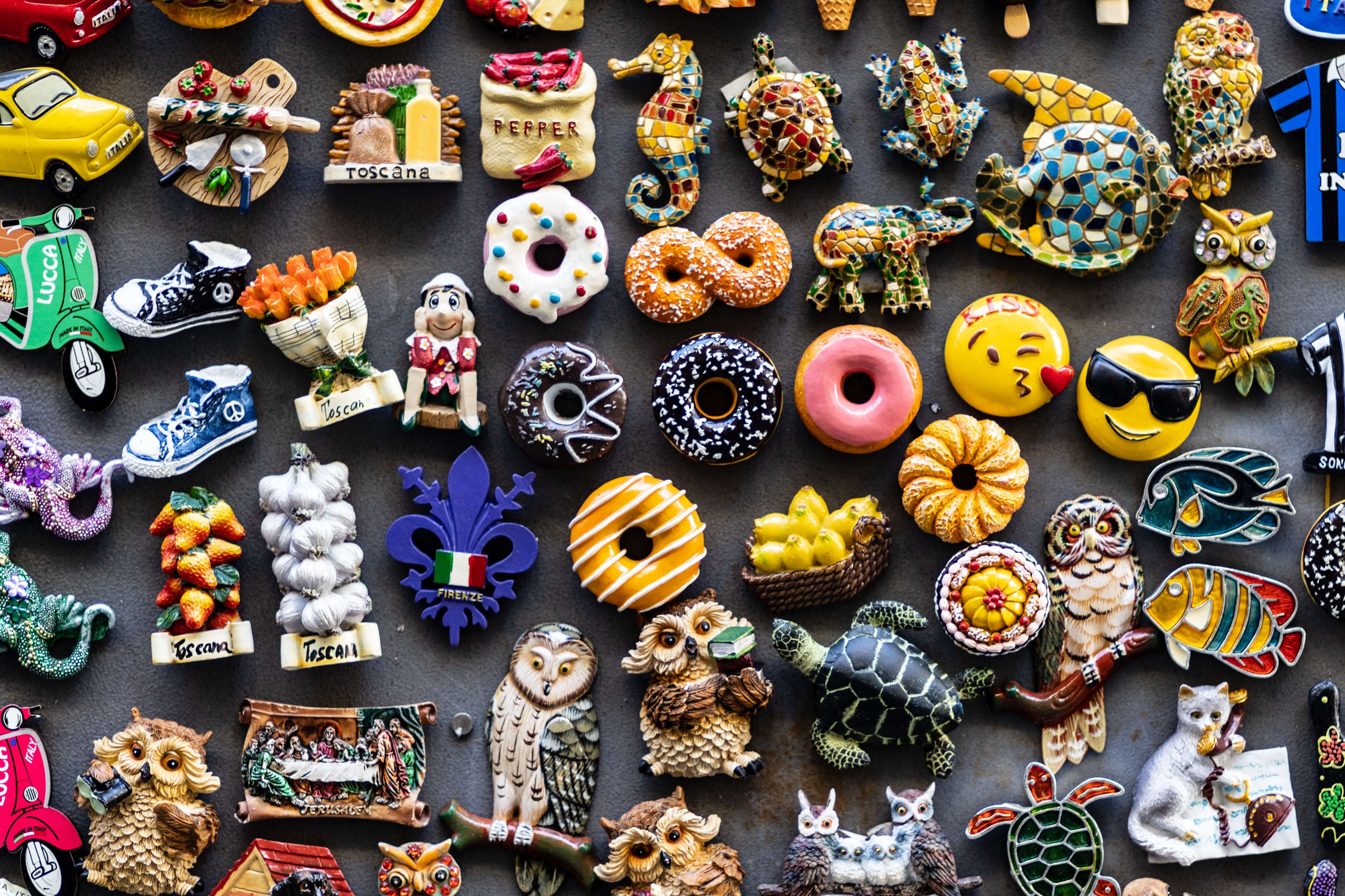 Magnets of various items including owls, donuts, emojis fish, and more