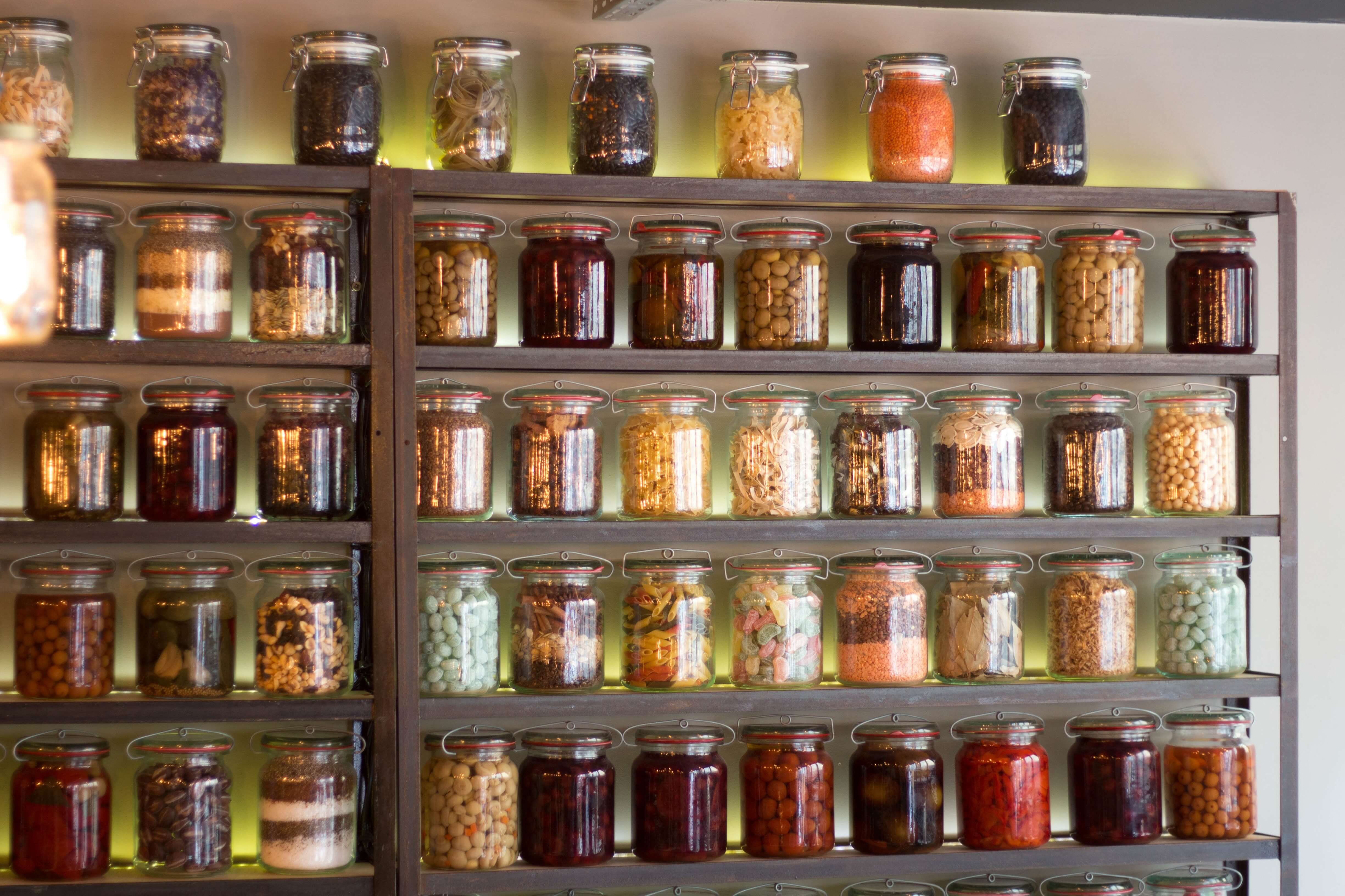 A series of jars arranged on a shelp