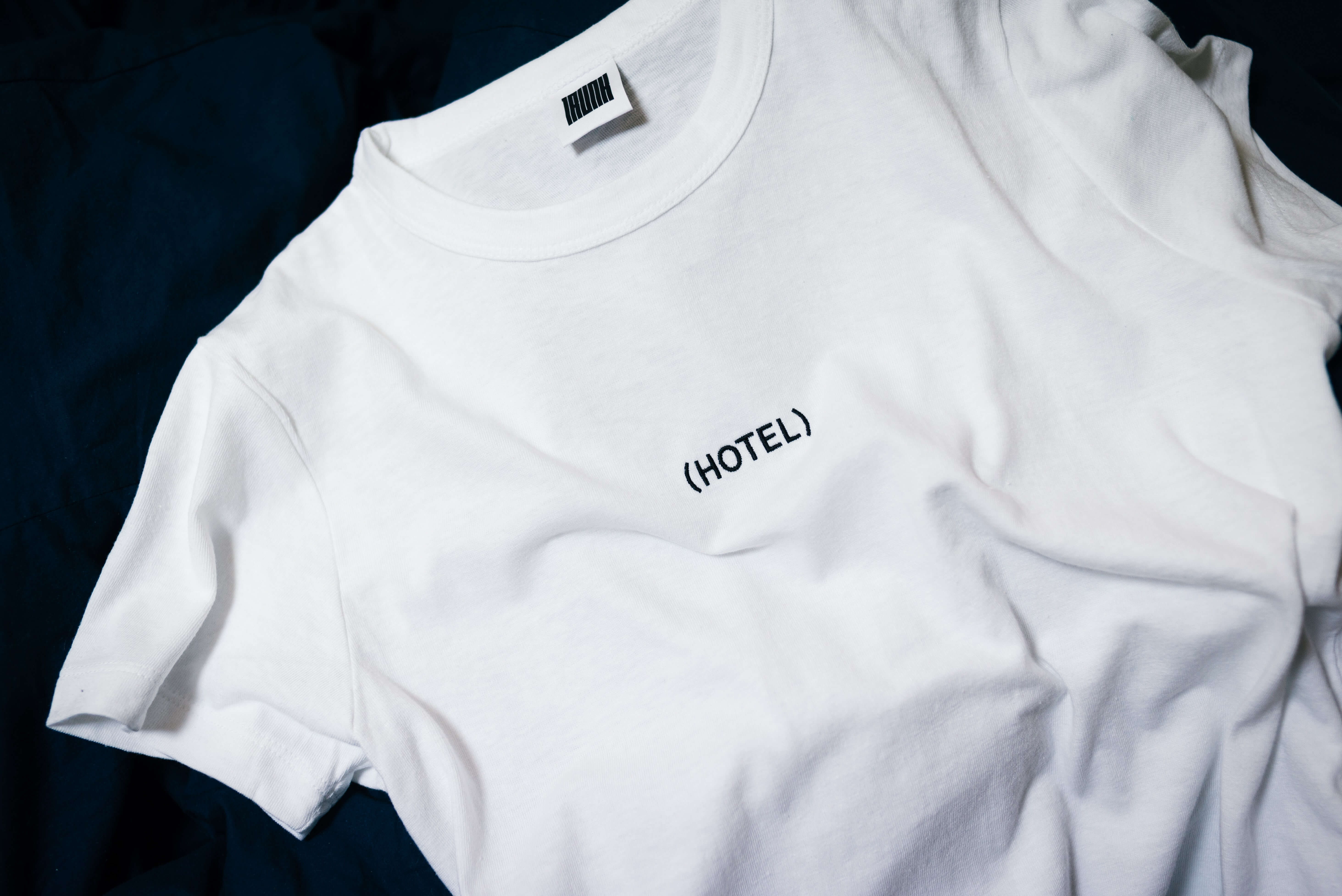 A white T-shirt with the word (HOTEL) printed on it