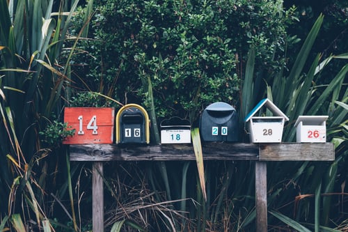 Six mailboxes in a forest