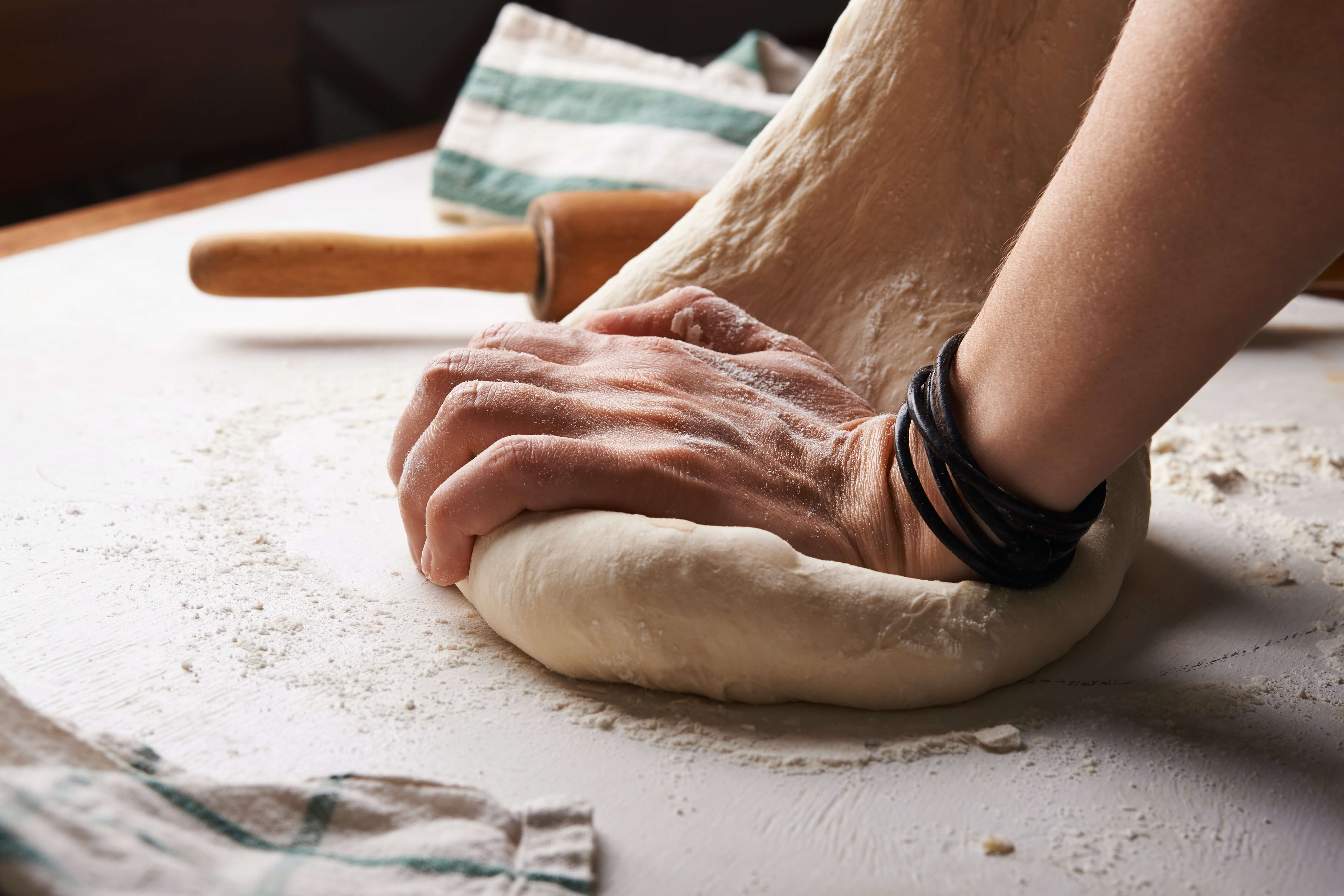 A person kneading dough
