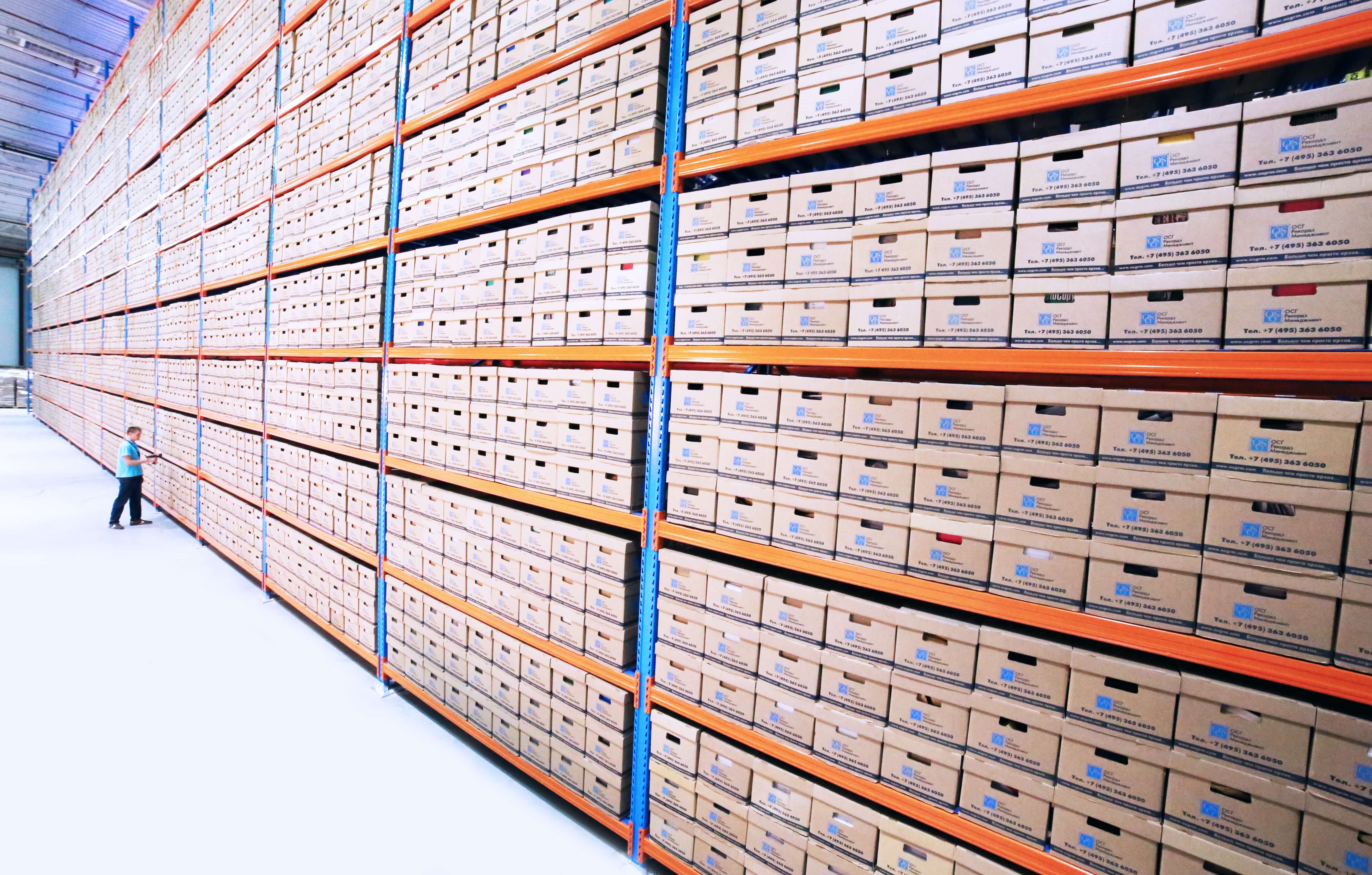 A person scanning boxes at a warehouse