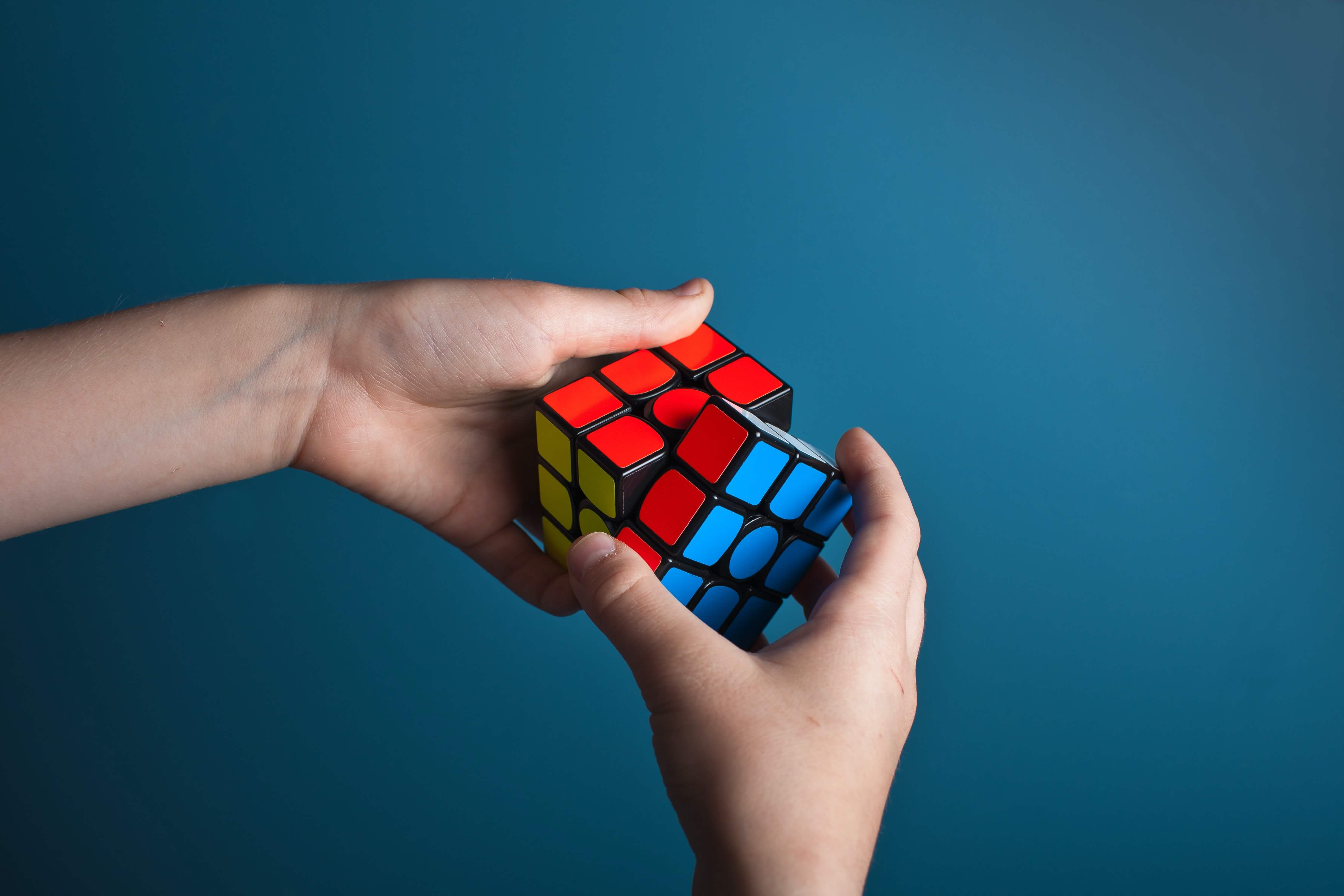 A pair of hands solving a Rubik's cube