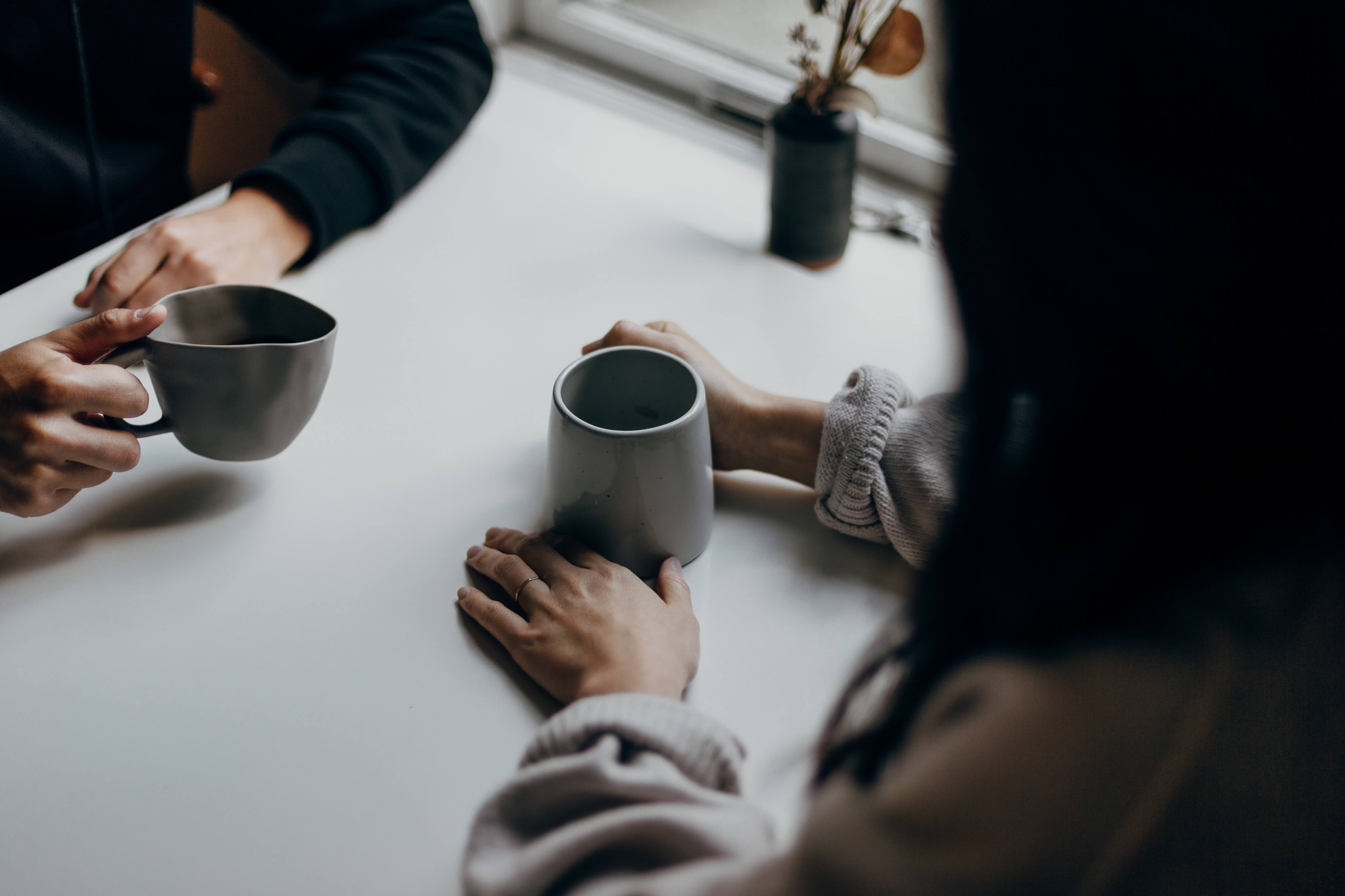 Two people chatting over coffee