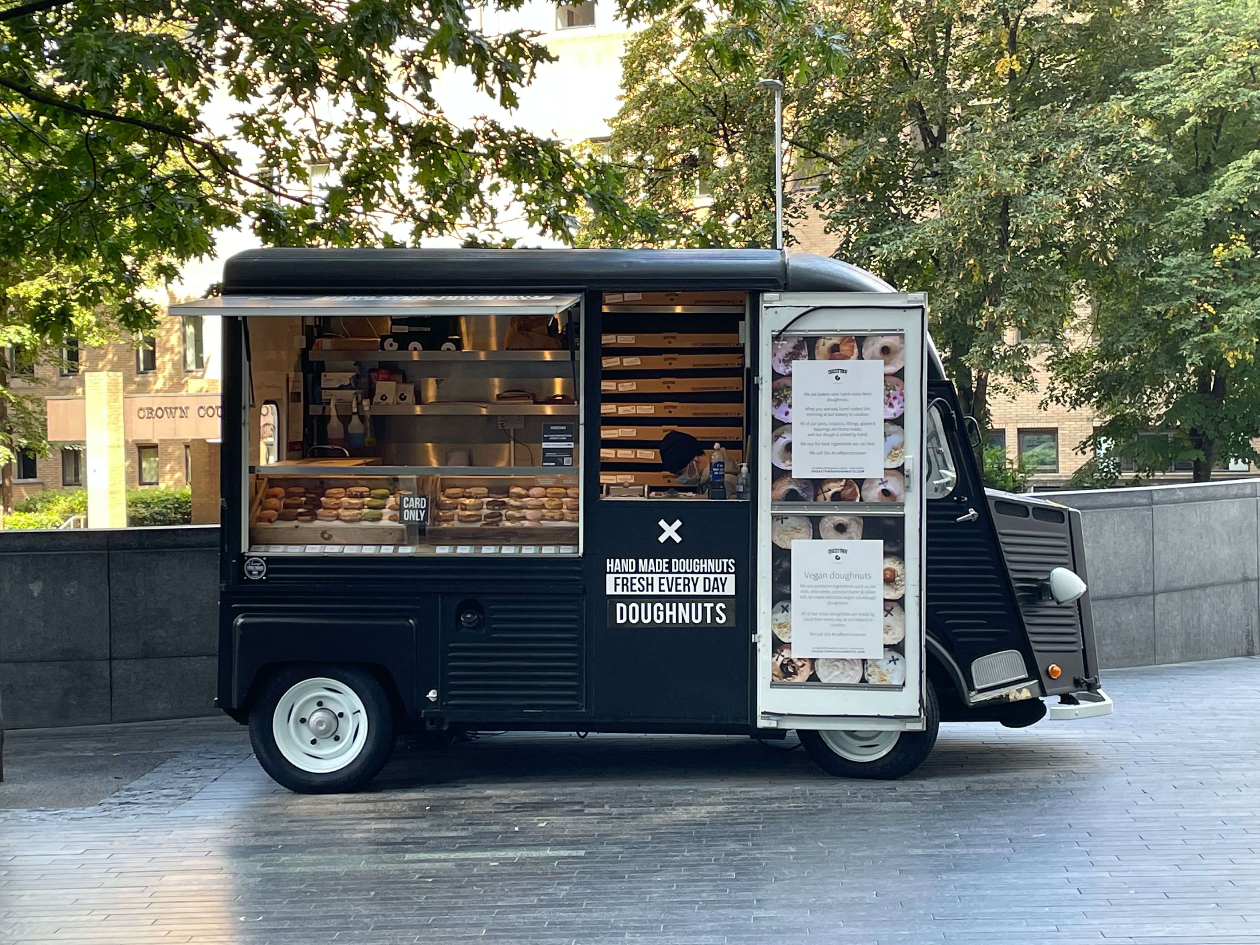 A small black donut truck