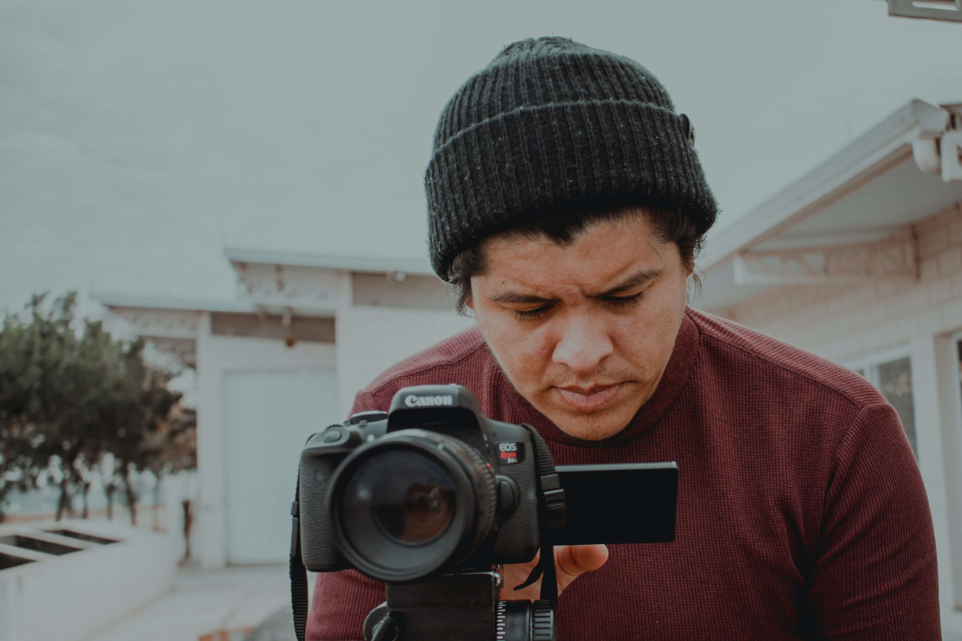 A man taking a photo with a camera on a tripod