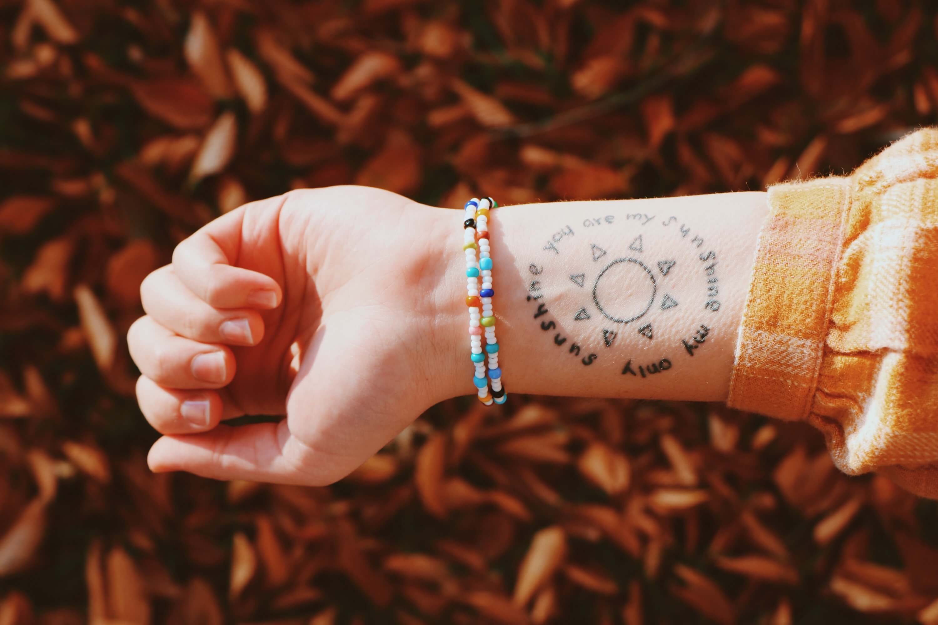 A had showing off a simple beaded bracelet