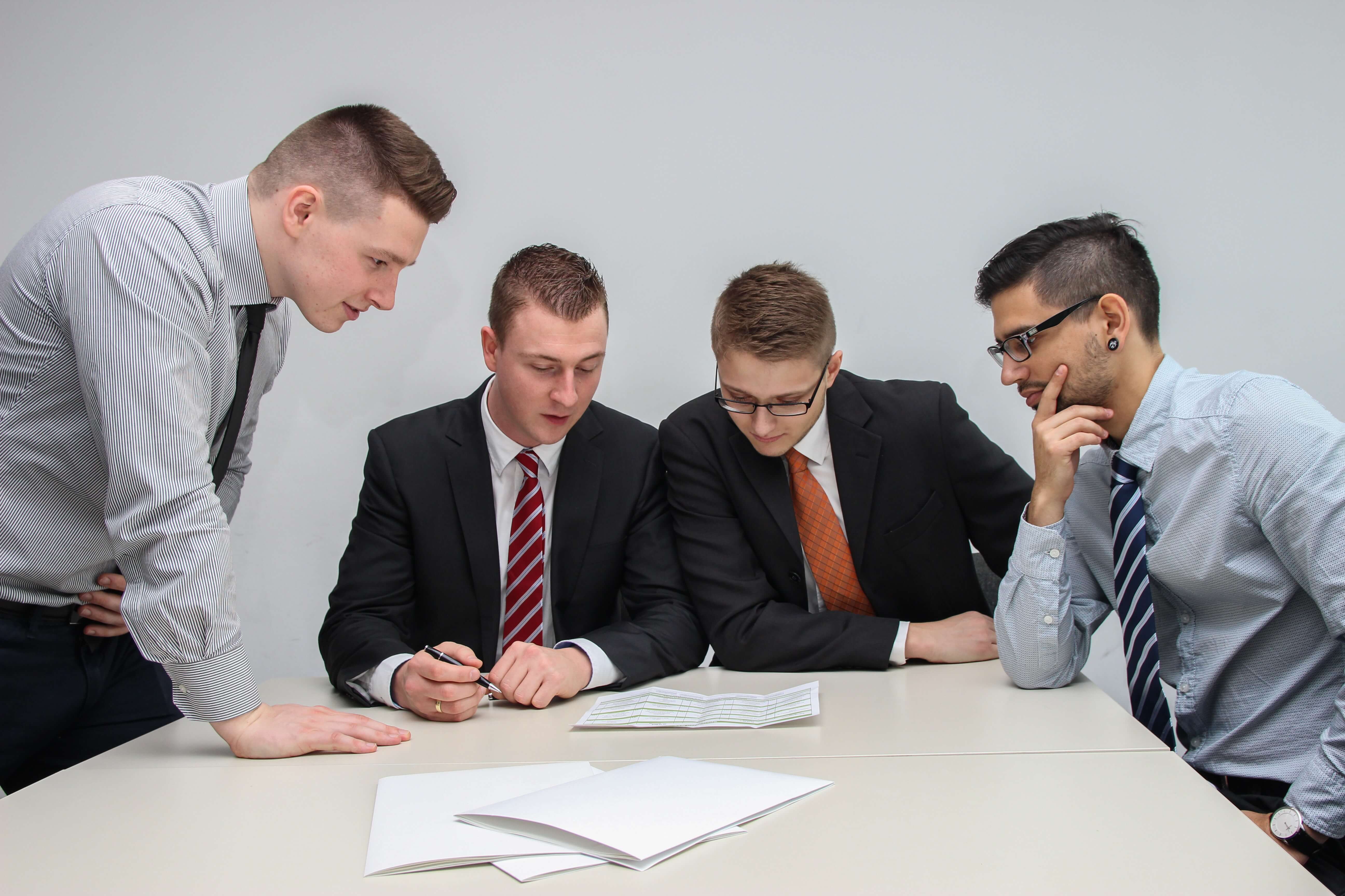 Four guys in business casual clothing at a meeting
