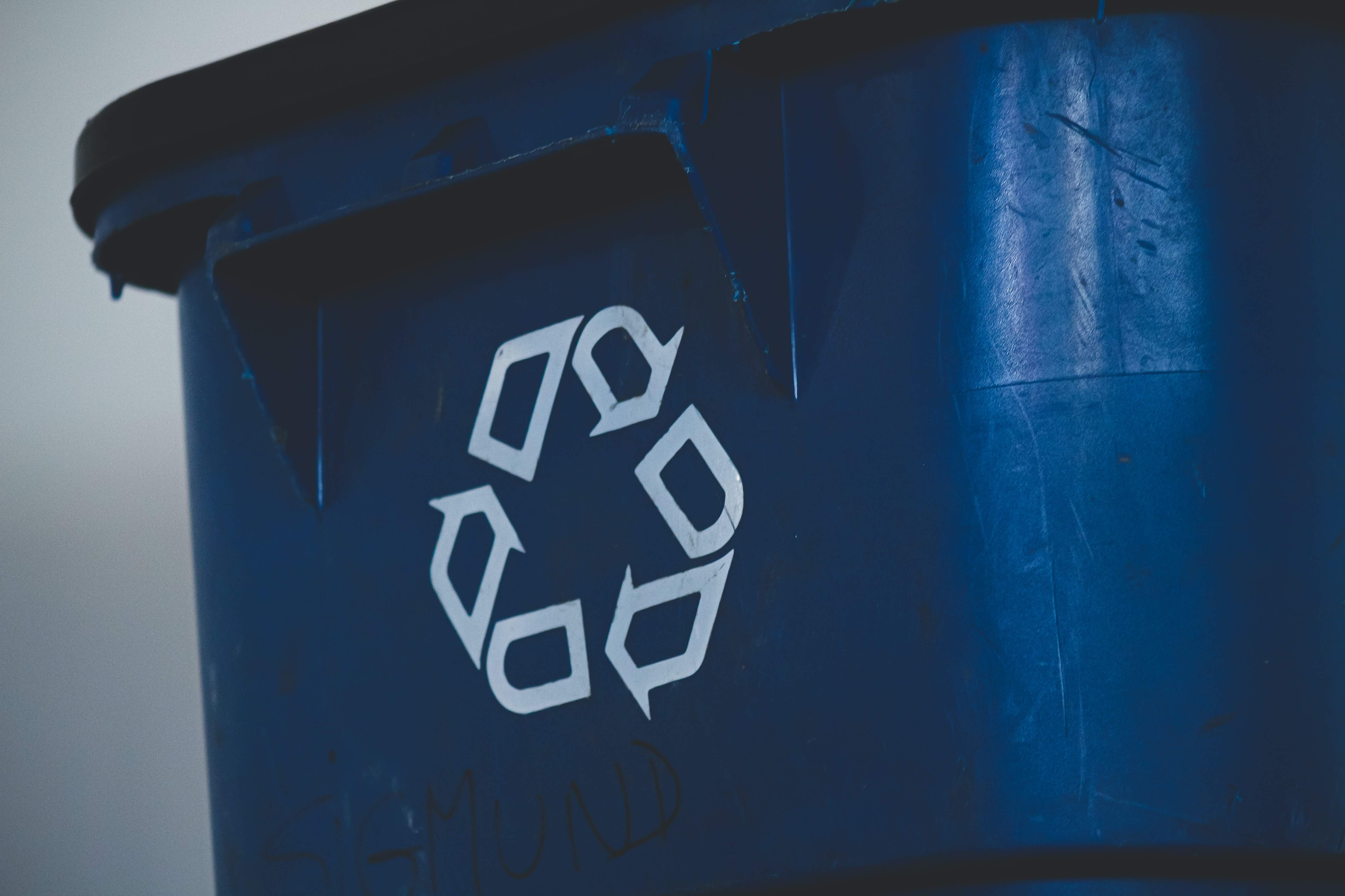 A recycling bin with the symbol on the front