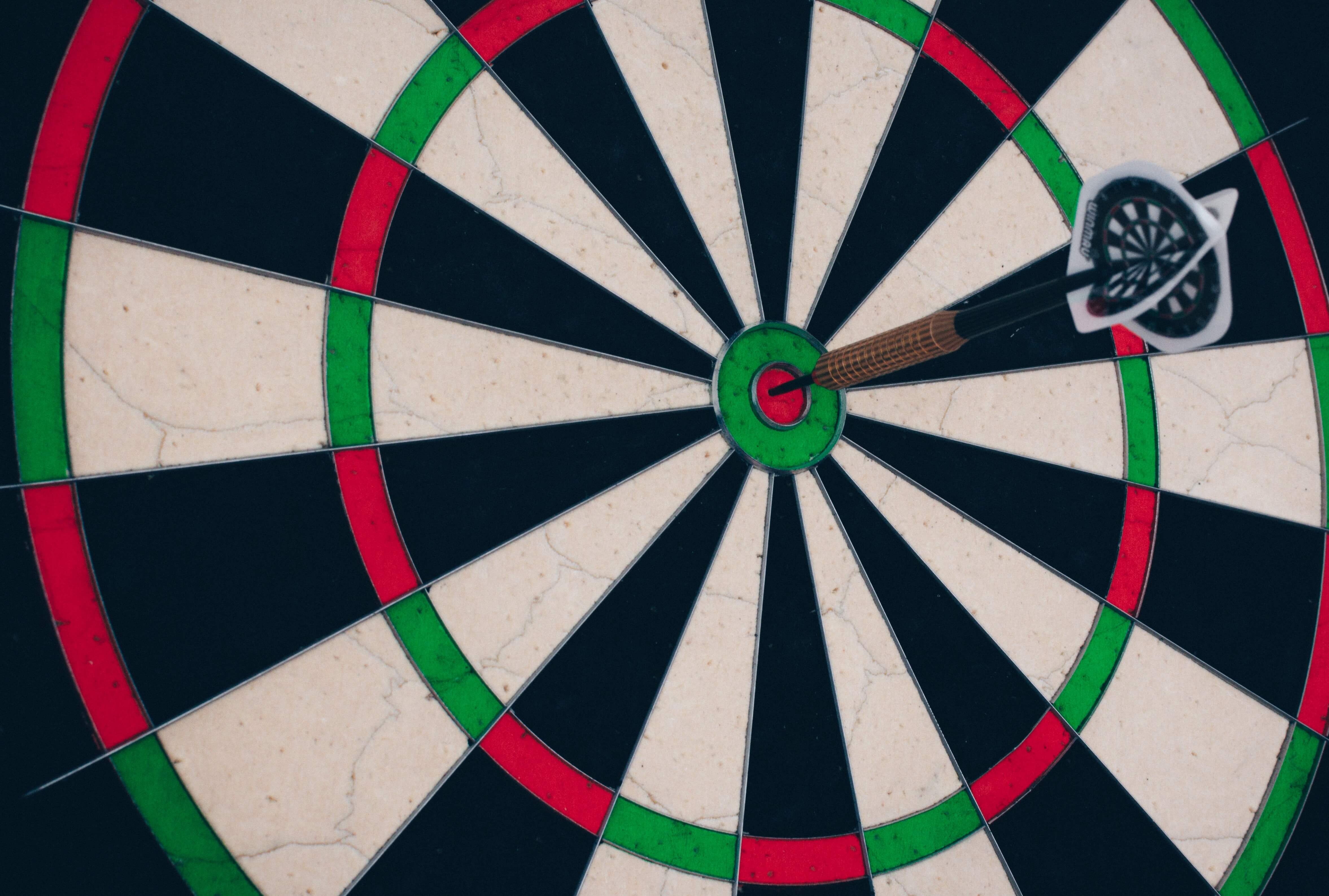 A dartboard with a dart on the bullseye