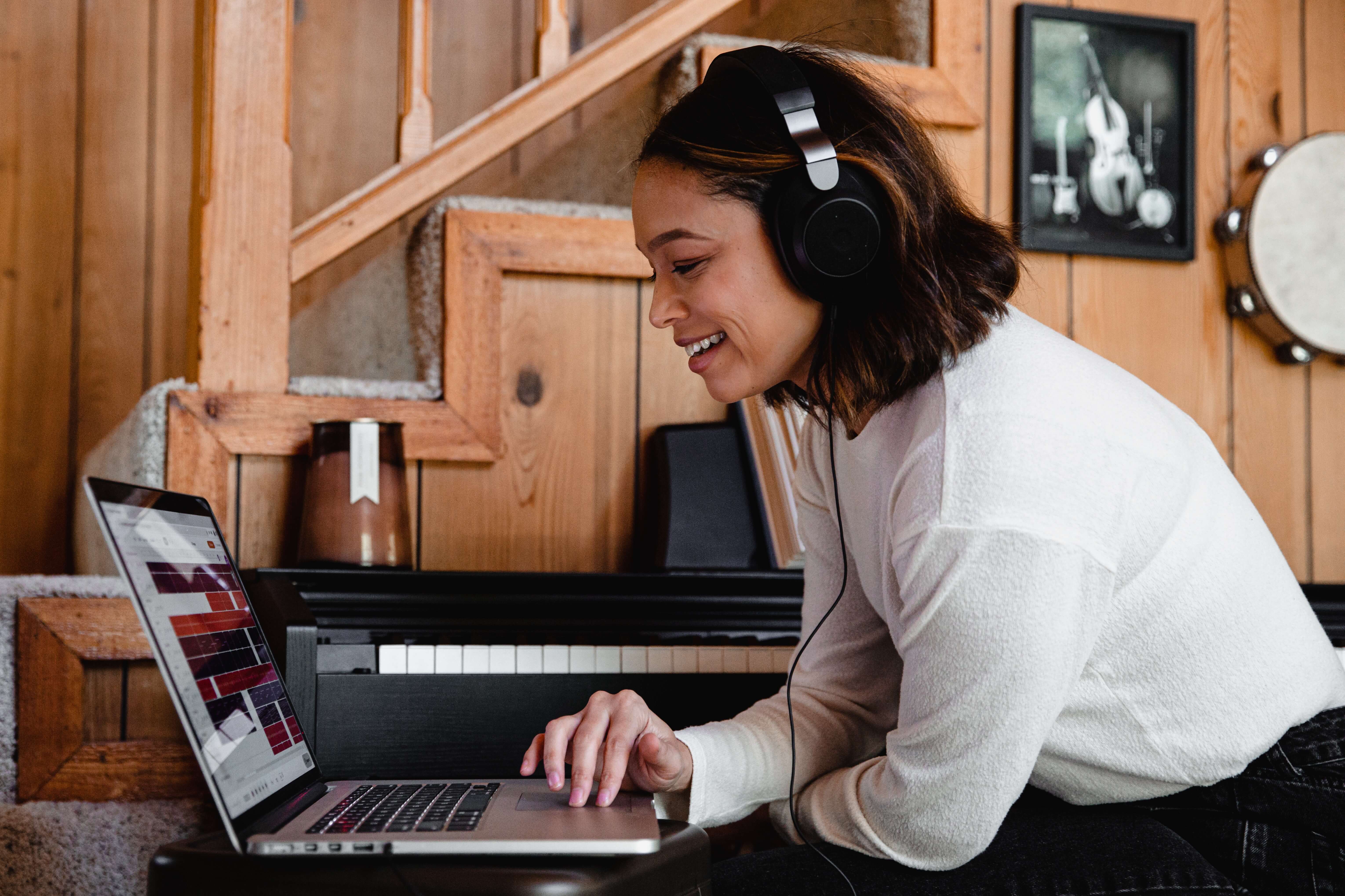 A woman listening to music on her laptop