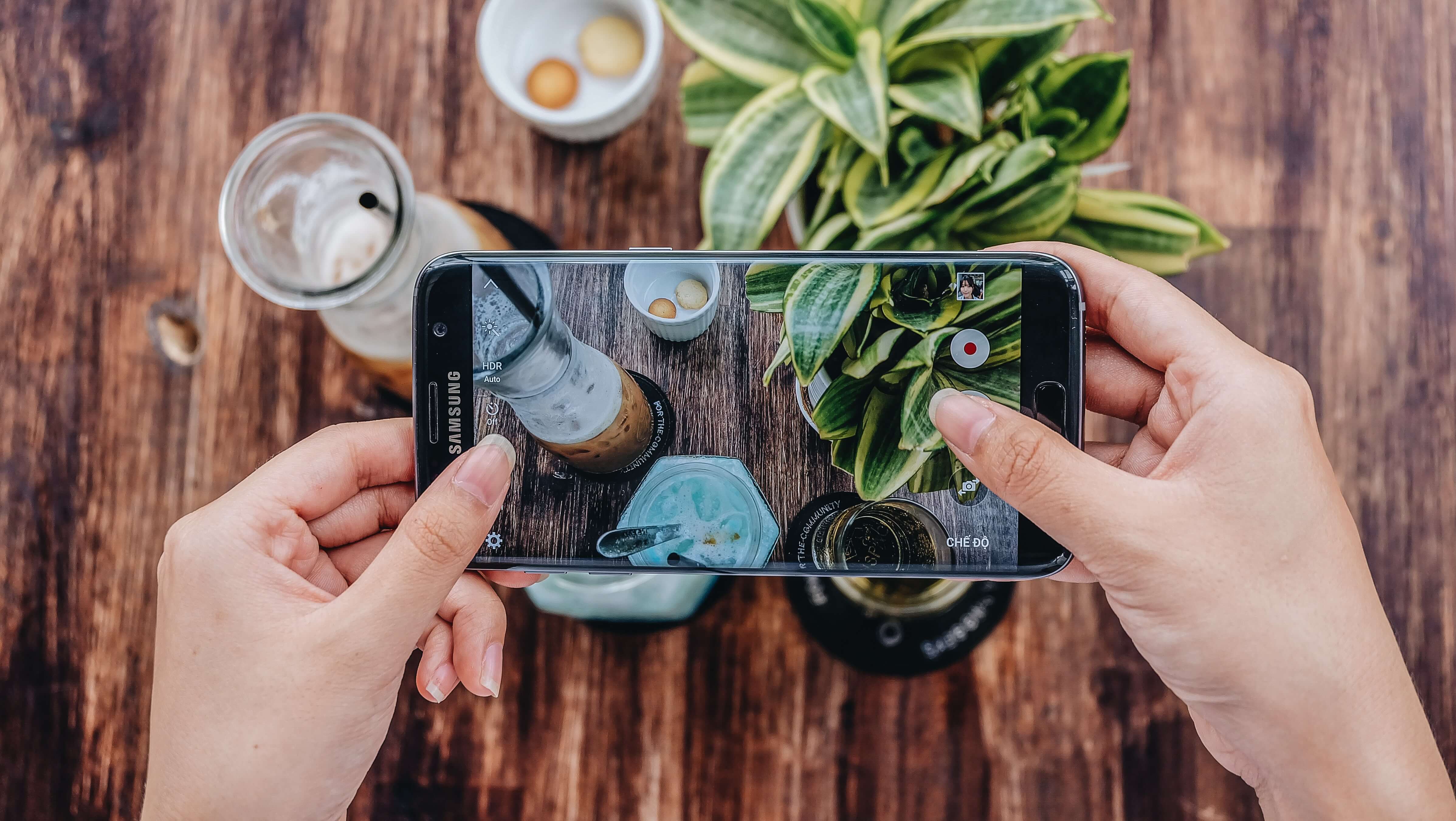 A person taking a photo of a meal from above