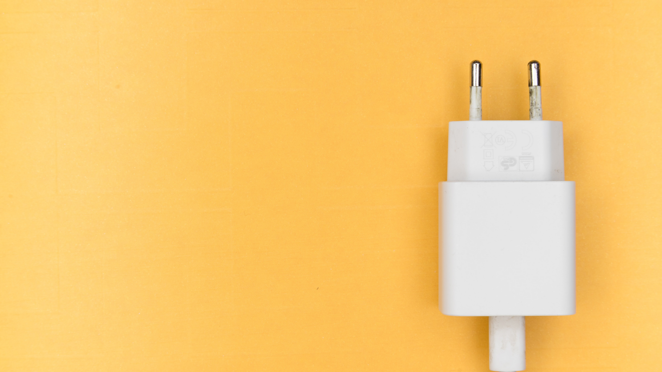 A plug against a yellow background