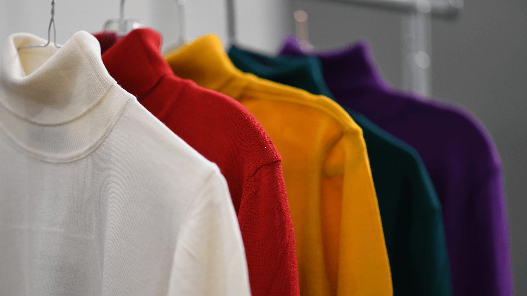 Colorful turtlenecks on a clothing rack